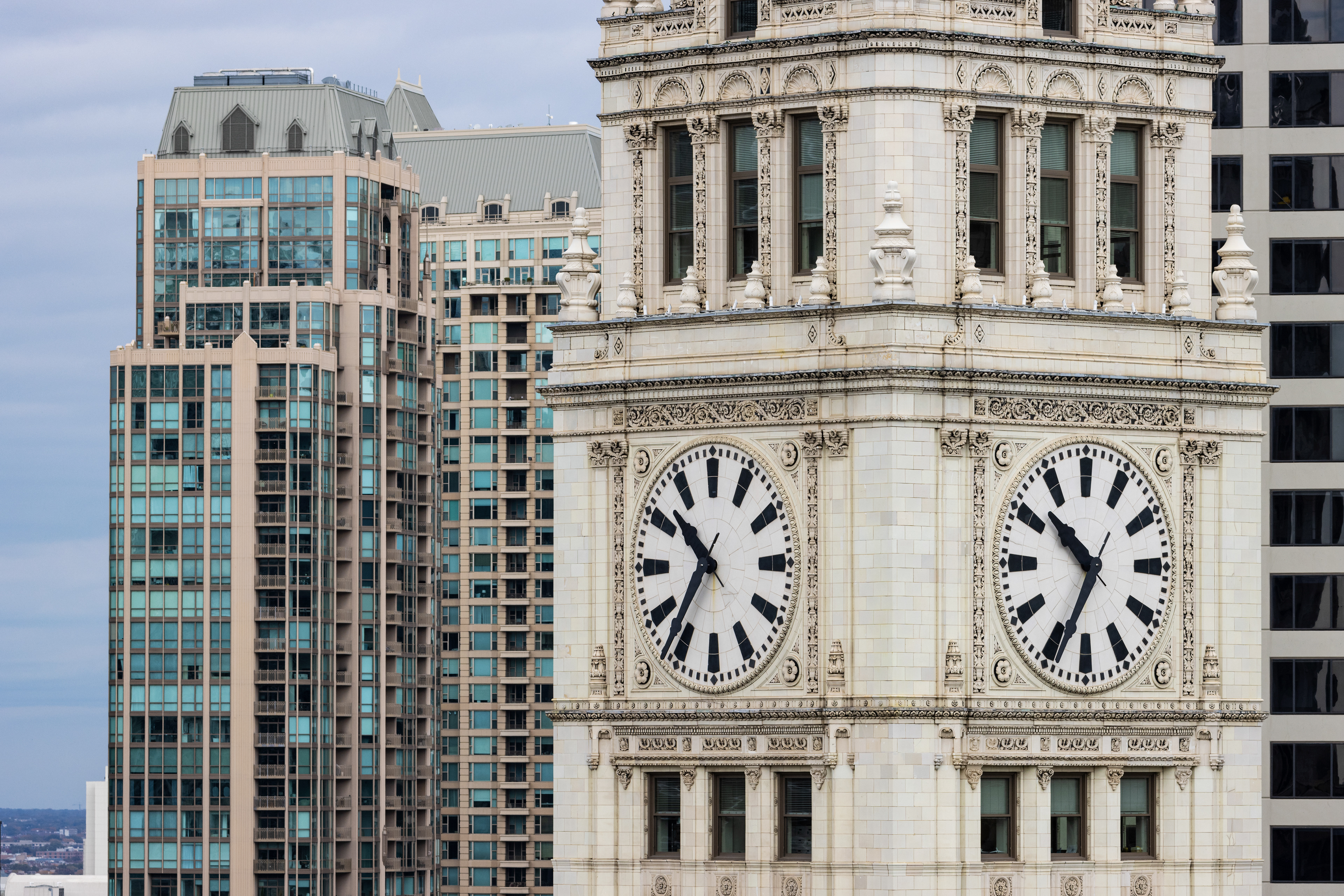 A decorative stone tower with a large clock face.