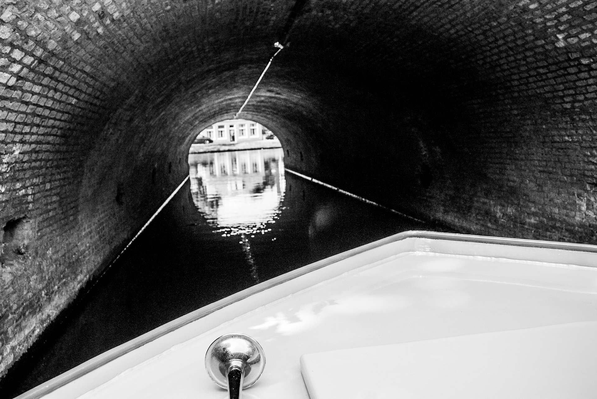 Boat entering into a canal in Alkmaar, Netherlands.