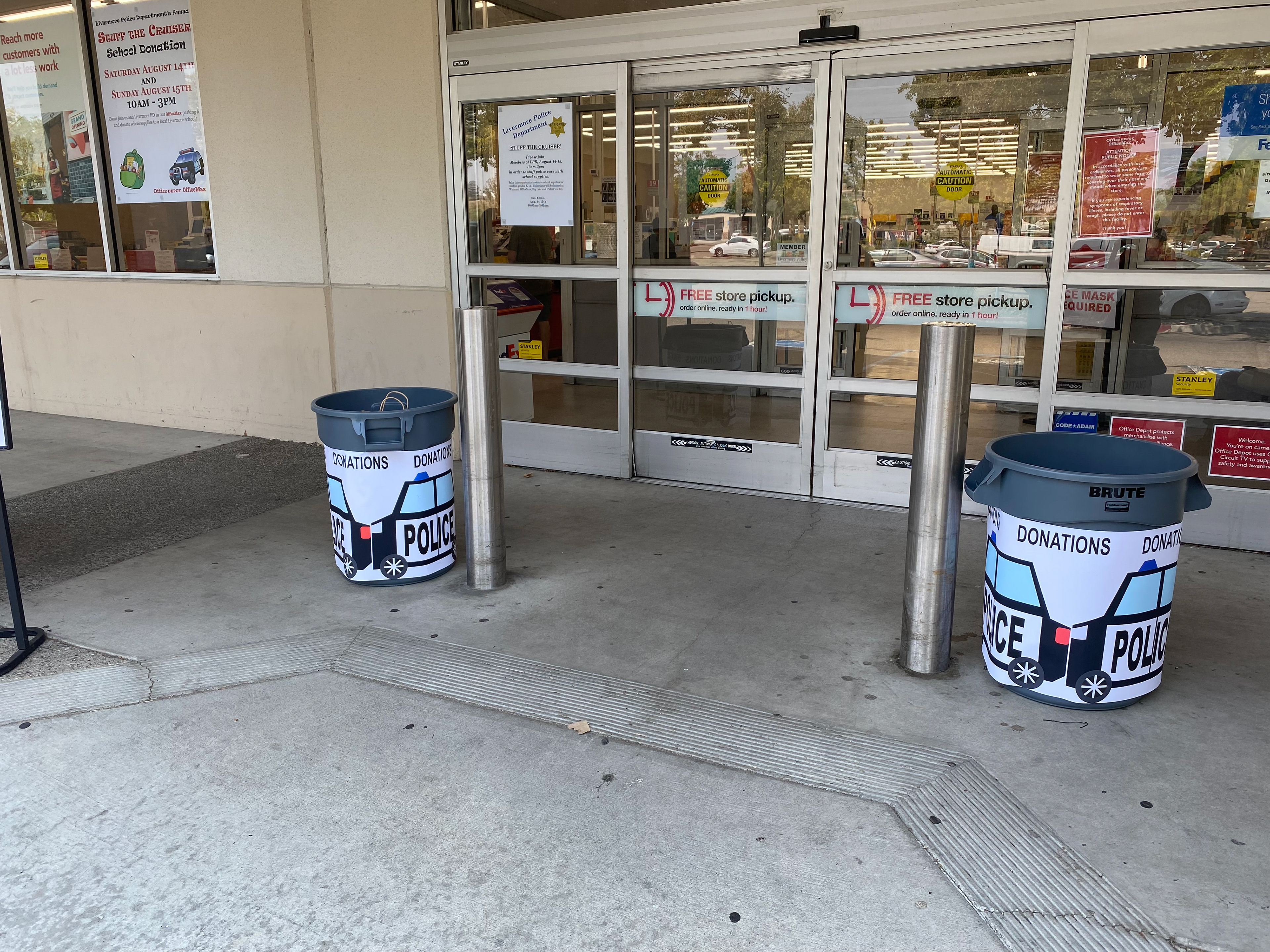 Two donation buckets decorated with a police-themed wrap with text on top that says "Donations."