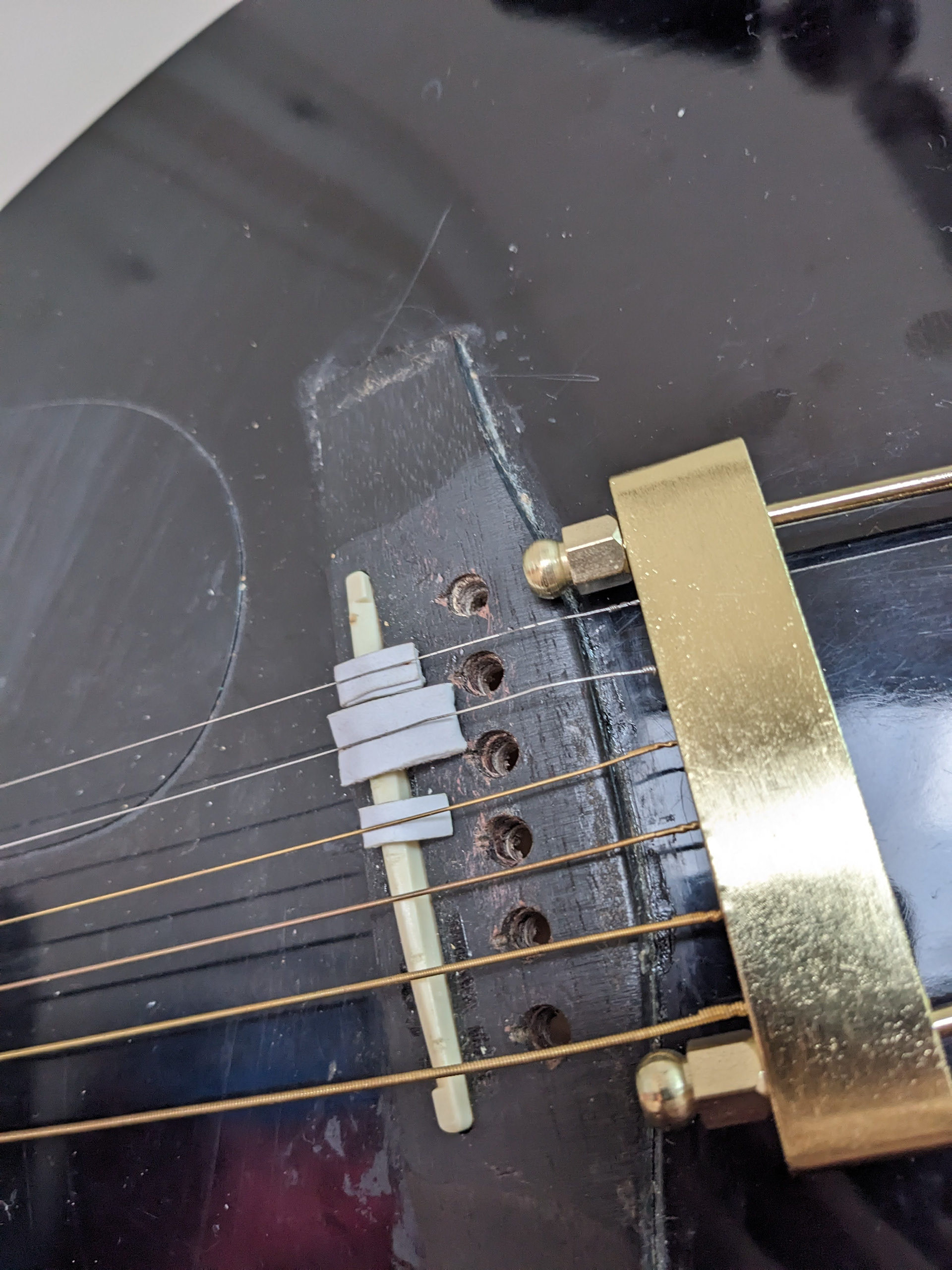 The bent bridge and the newly added bridge on my guitar