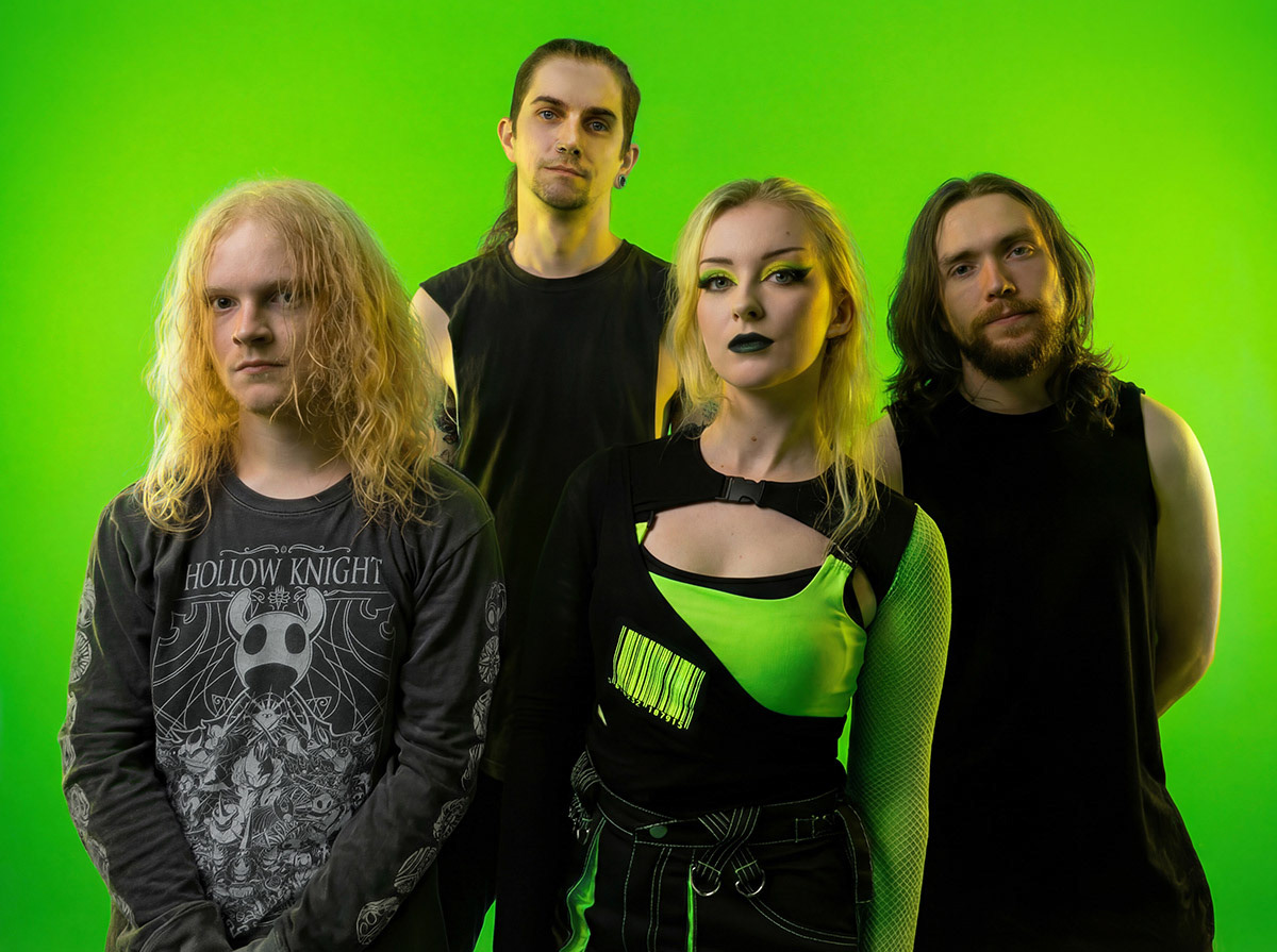 4-piece band stood in vibrant green and black