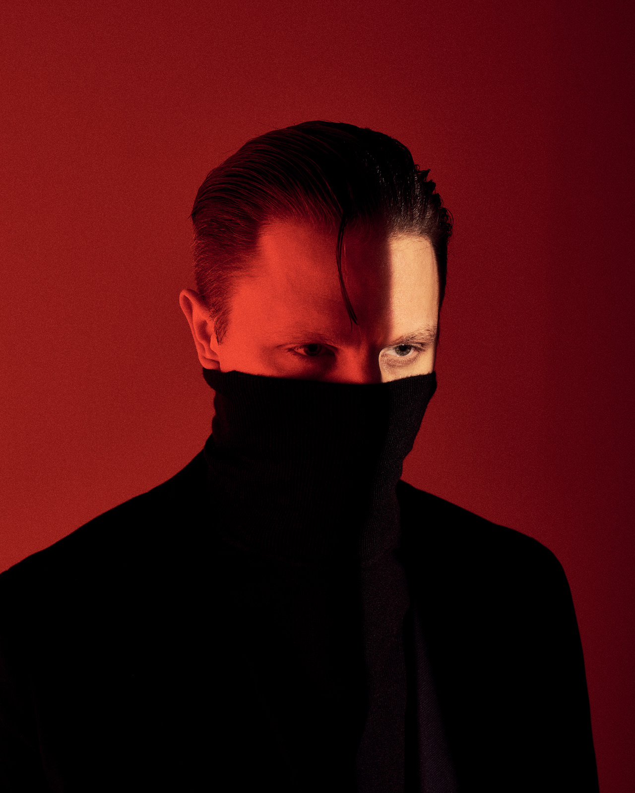 Portrait of a man in front of red background