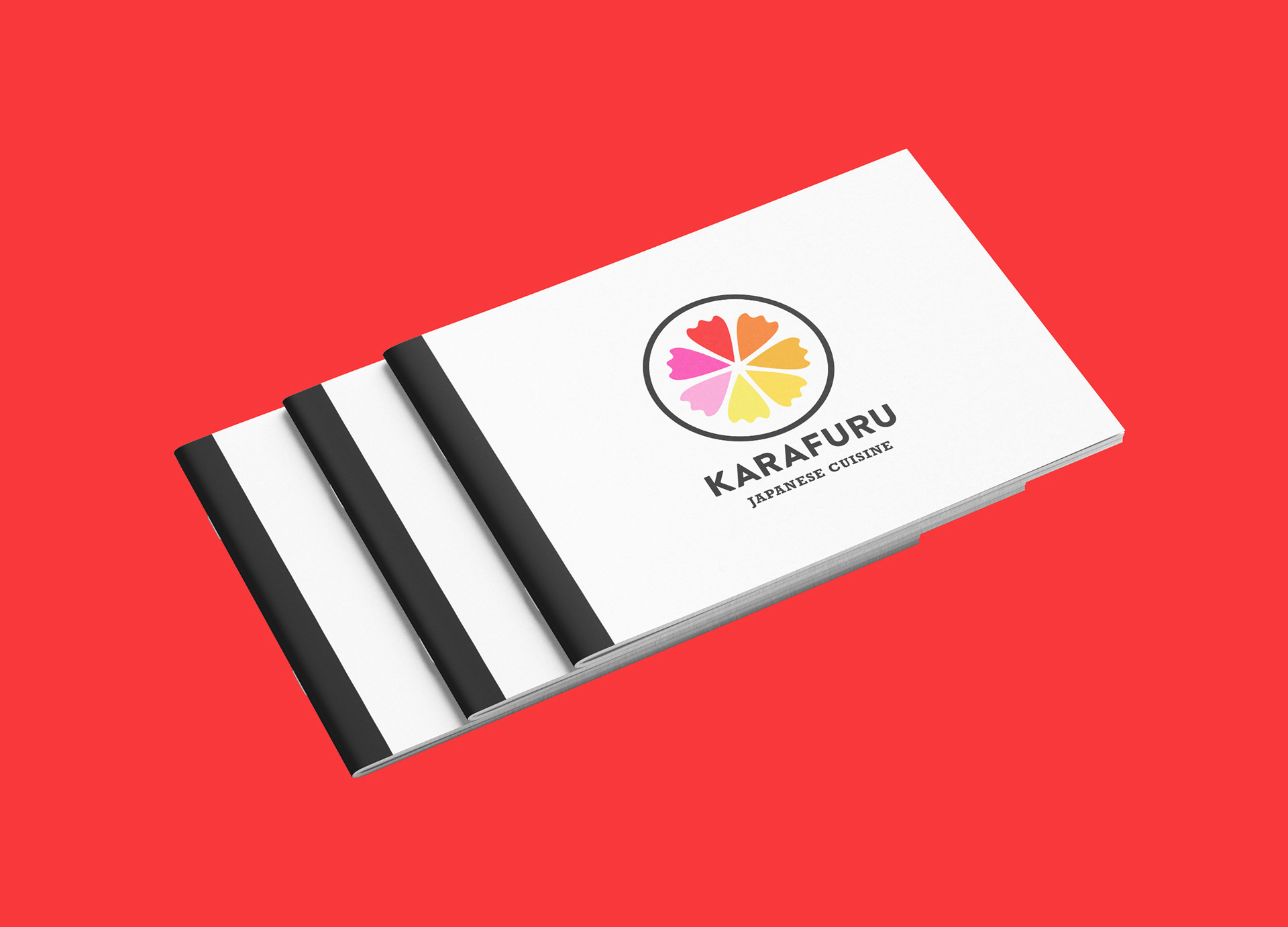 Three stacked, white menus with a black spine. Karafuru logo located right in the middle.