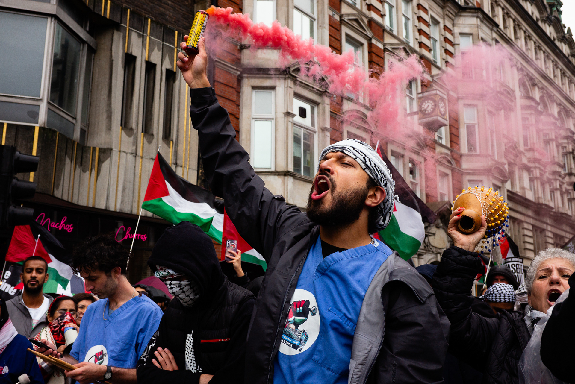London, UK. 6th July, 2024. A member of Health Workers 4 Palestine holds a smoke flare during the National March for Palestine, organised by the Palestine Solidarity Campaign (PSC) and other partner organisations to protest the ongoing military action in Gaza, to call for a ceasefire, and express solidarity with Palestine.