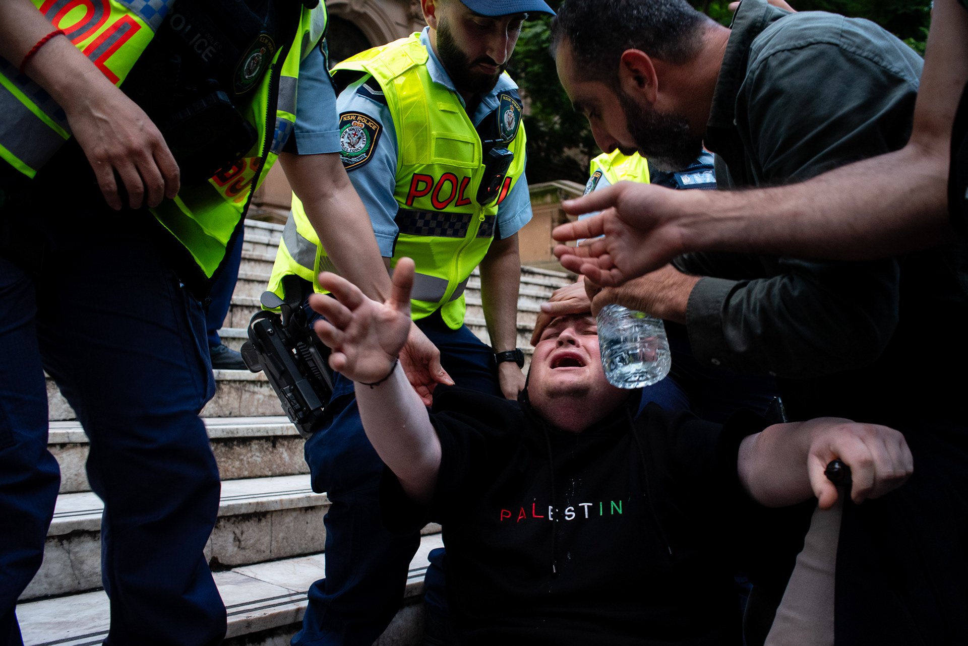 Sydney, Australia. 9 February 2026. NSW Police remove a protester affected by pepper spray away from the scene during clashes at a demonstration opposing the visit of Israeli President Isaac Herzog outside Sydney Town Hall.