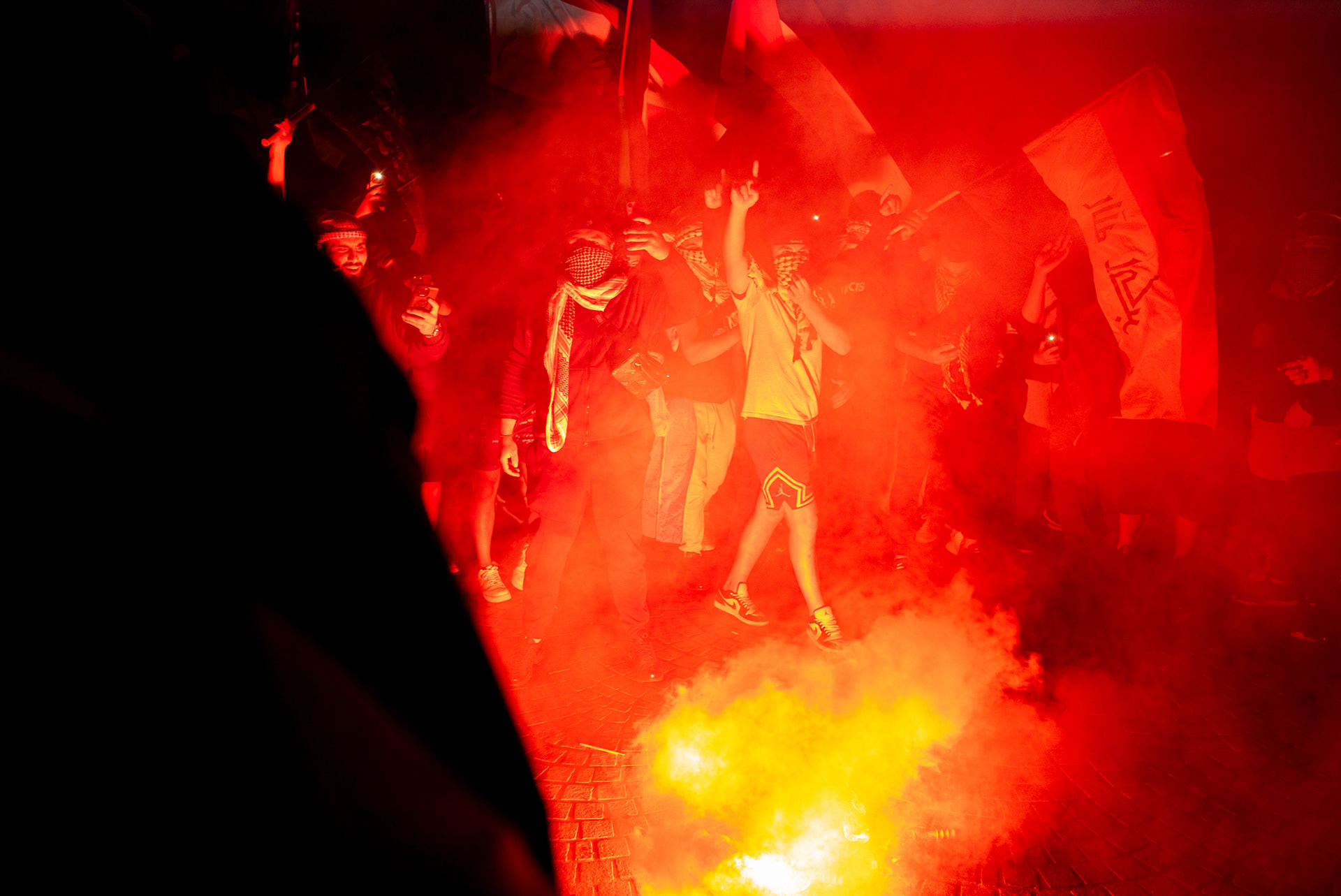 Sydney, Australia. 9th Oct, 2023. Pro-Palestine protestors burn flares at Sydney Opera House. The protestors marched down to the Sydney Opera House from an earlier rally at Sydney Town Hall. The protest was specifically redirected to the Opera House forecourt in response to the New South Wales government's decision to illuminate the building's sails in blue and white in solidarity with Israel following the October 7 attacks. Participants called for an end to Australian support for Israel and protested against the escalating conflict in Gaza. The event was marked by high tension, a significant police presence, and later became a subject of intense political debate in Australia.