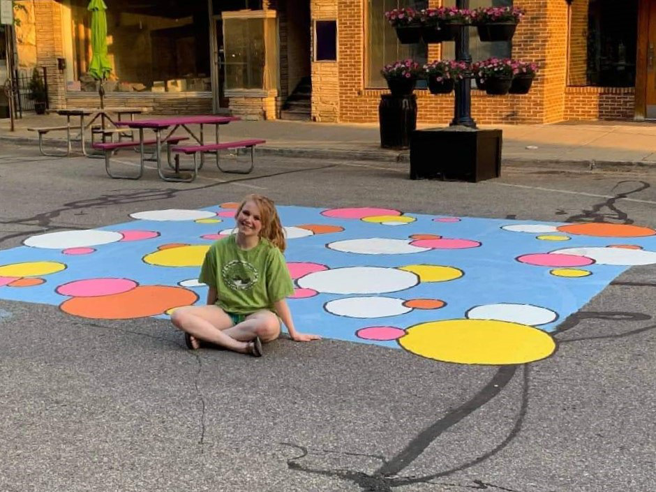 Image of me after finishing the street mural created for the City of Mt. Pleasant