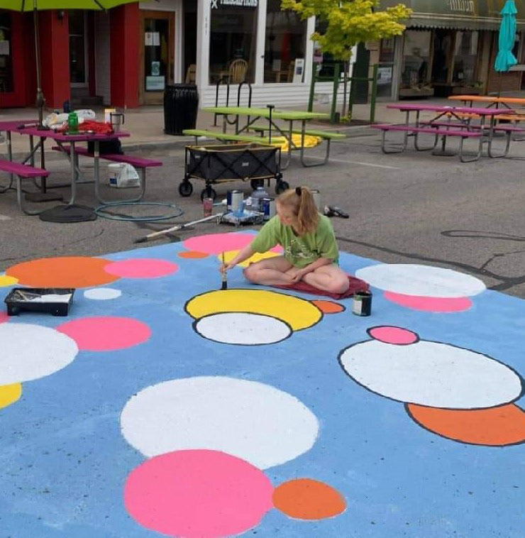 Image of me painting the street mural for the City of Mt. Pleasant