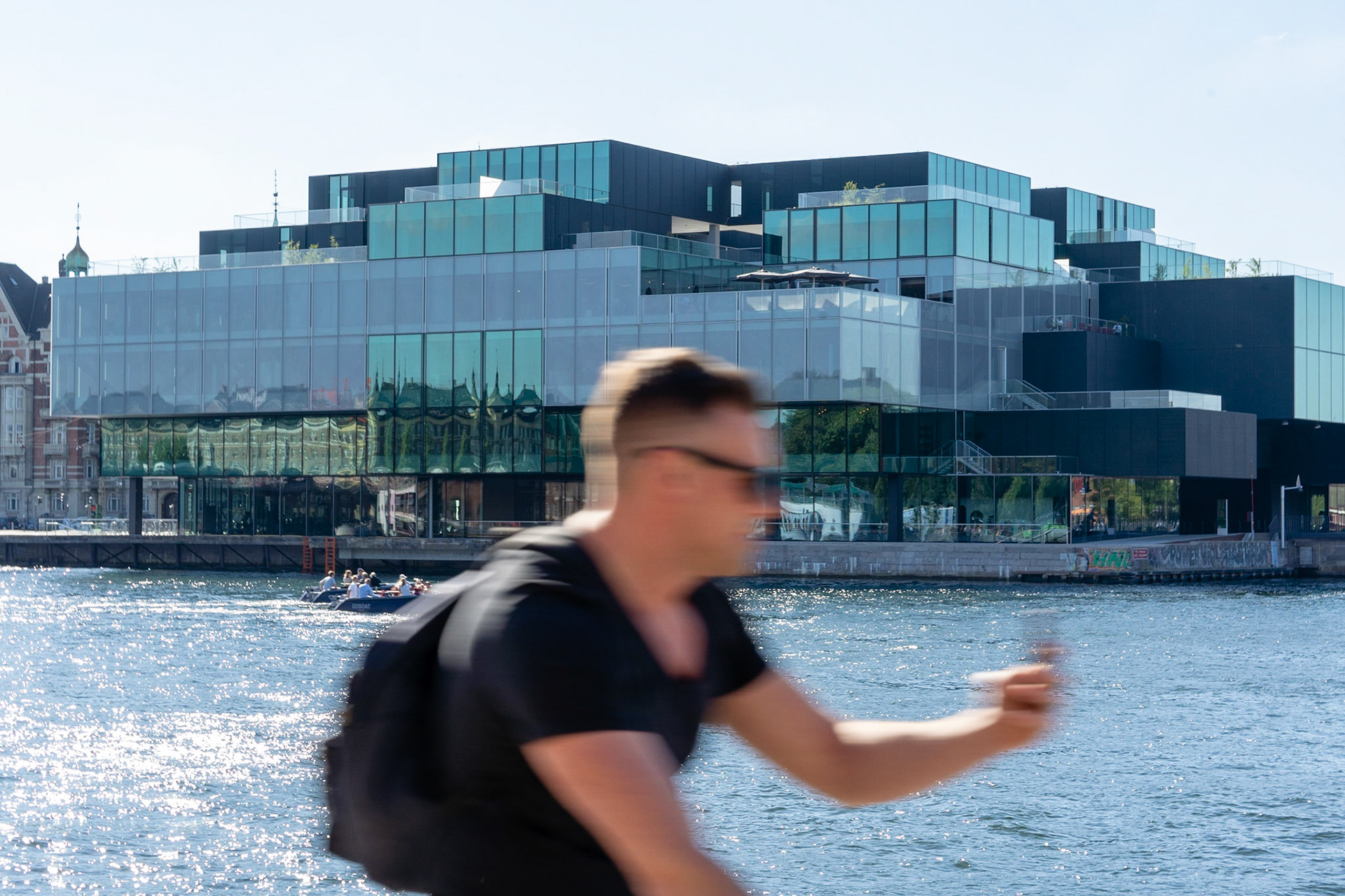 The Blox building from 2018 by the Copenhagen waterfront, domicile for DAC, Dansk Arkitektur Center. Bicyclist in front.