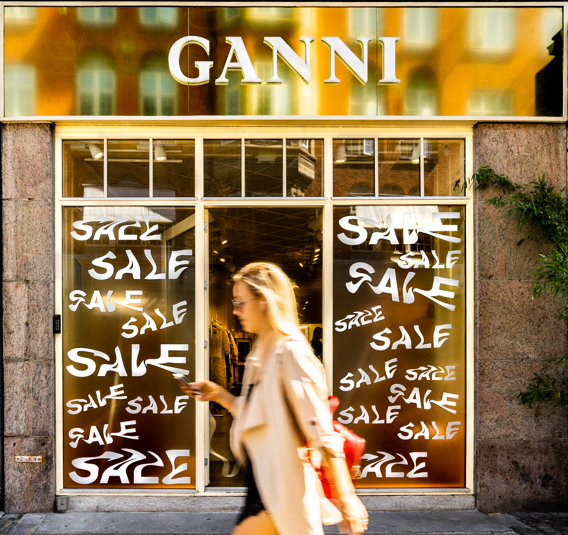 Ganni flagship store in Copenhagen, girl passing by