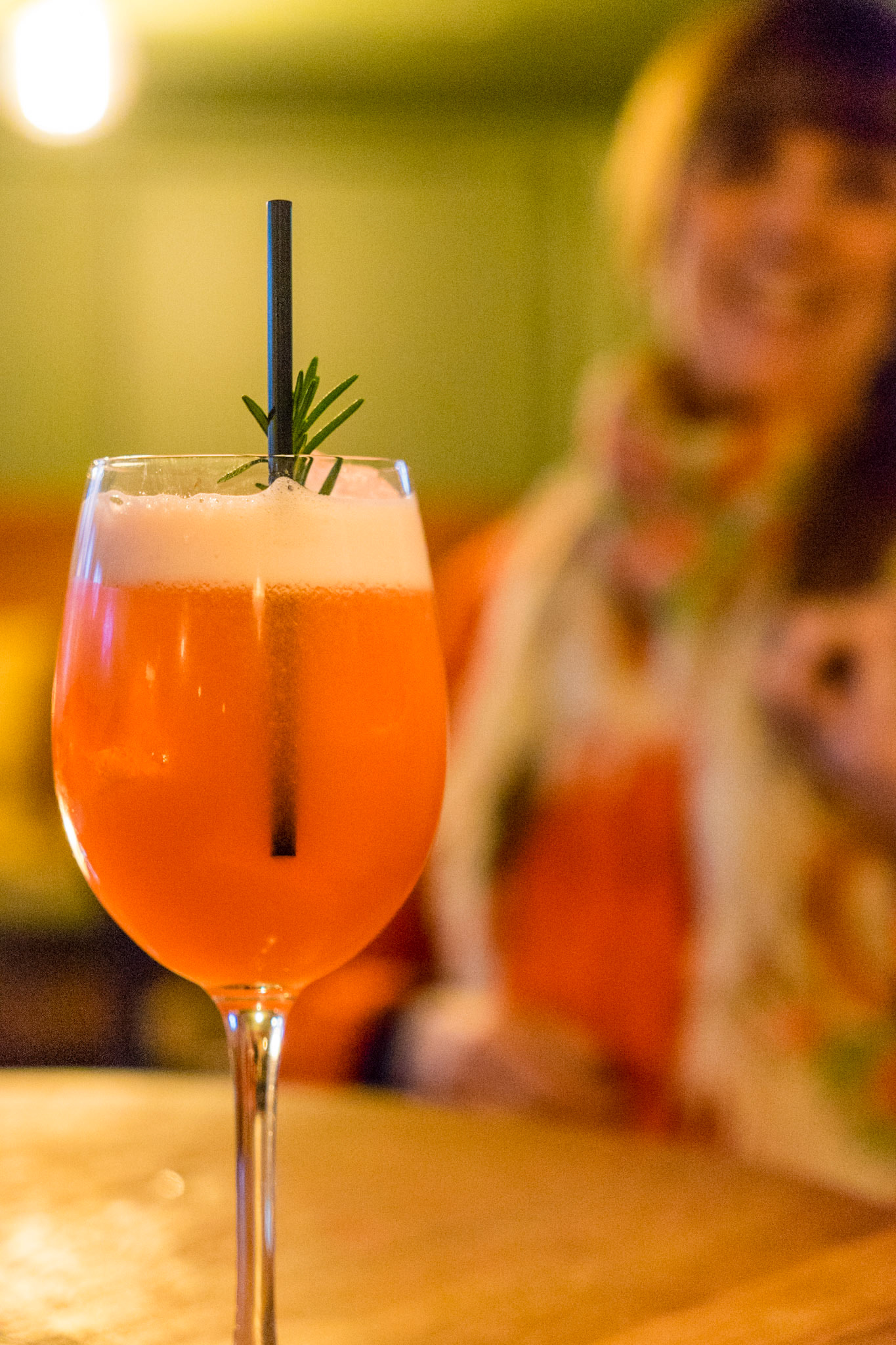 Orange drink, woman in background