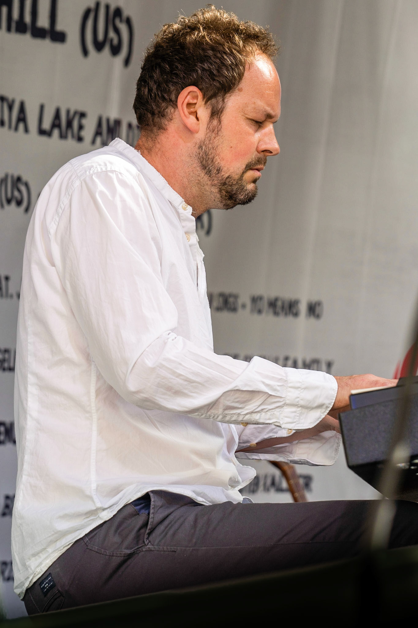 Swedish musician  Gustav Ljunggren on stage with Kira Skov and Howe Gelb in Copenhagen Jazz Festival on Balders Plads (Balder's Square), Copenhagen