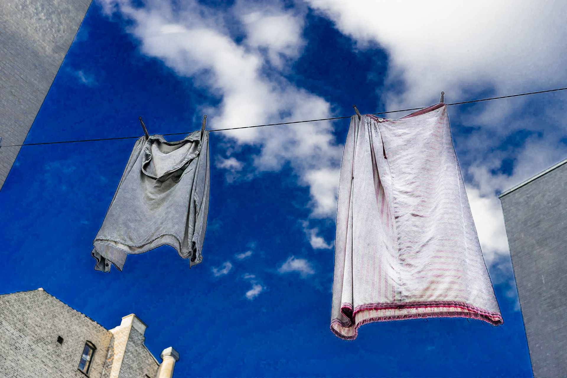 Laundry hanging in yard, blue sky in background, Workers' museum in Copenhagen