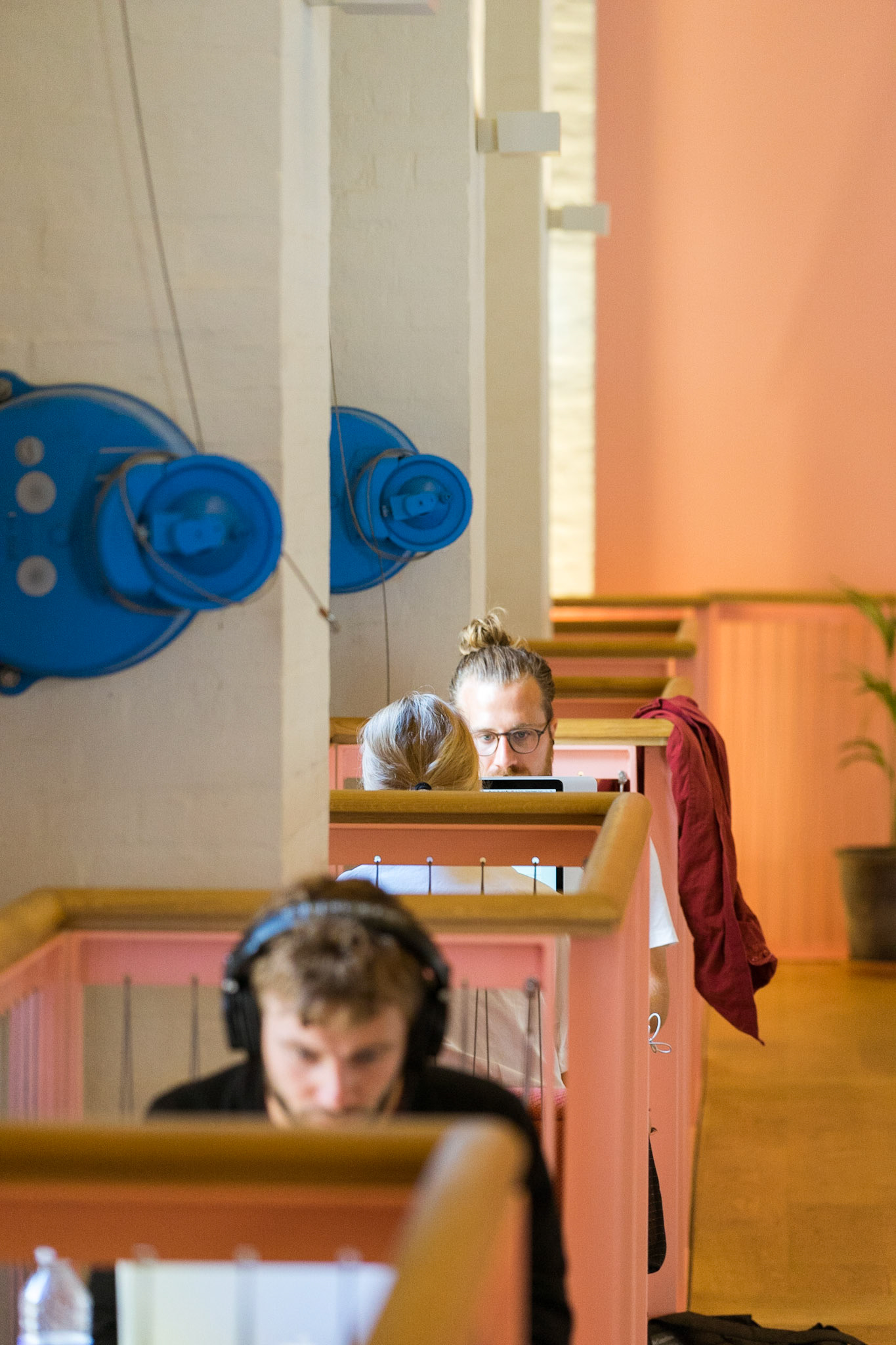 People relaxing/working in Absalon, Copenhagen, Denmark - community house, created by Lennart Lajboschitz, founder of Flying Tiger retail chain