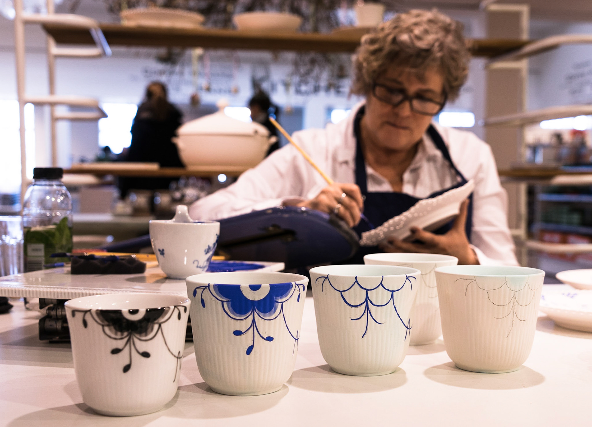 Artist from Royal Copenhagen painting the Blue Fluted motif