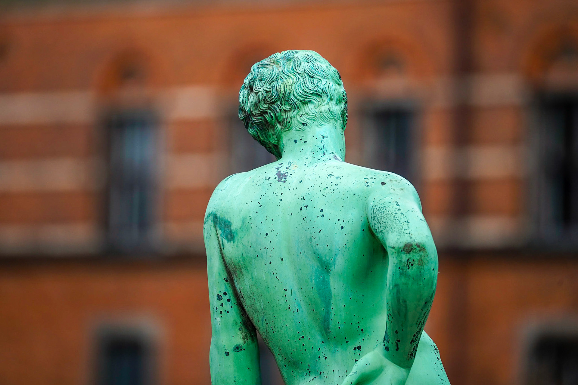 Statue of Narcissus, Roman copy of Greek original by unknown artist from 5th century BC, Museum of Geology in the background