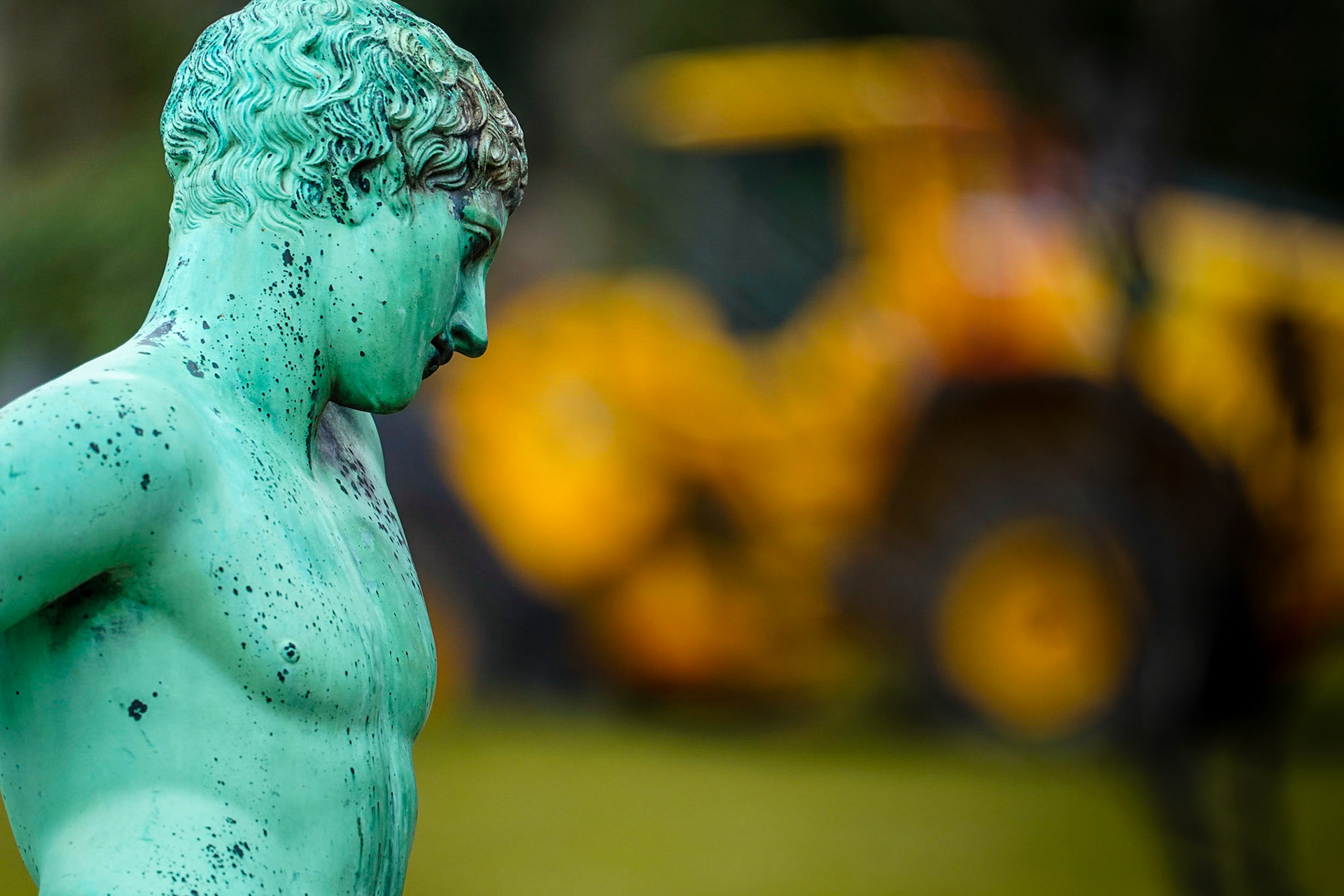Statue of Narcissus, Roman copy of Greek original by unknown artist from 5th century BC, yellow excavator in the background