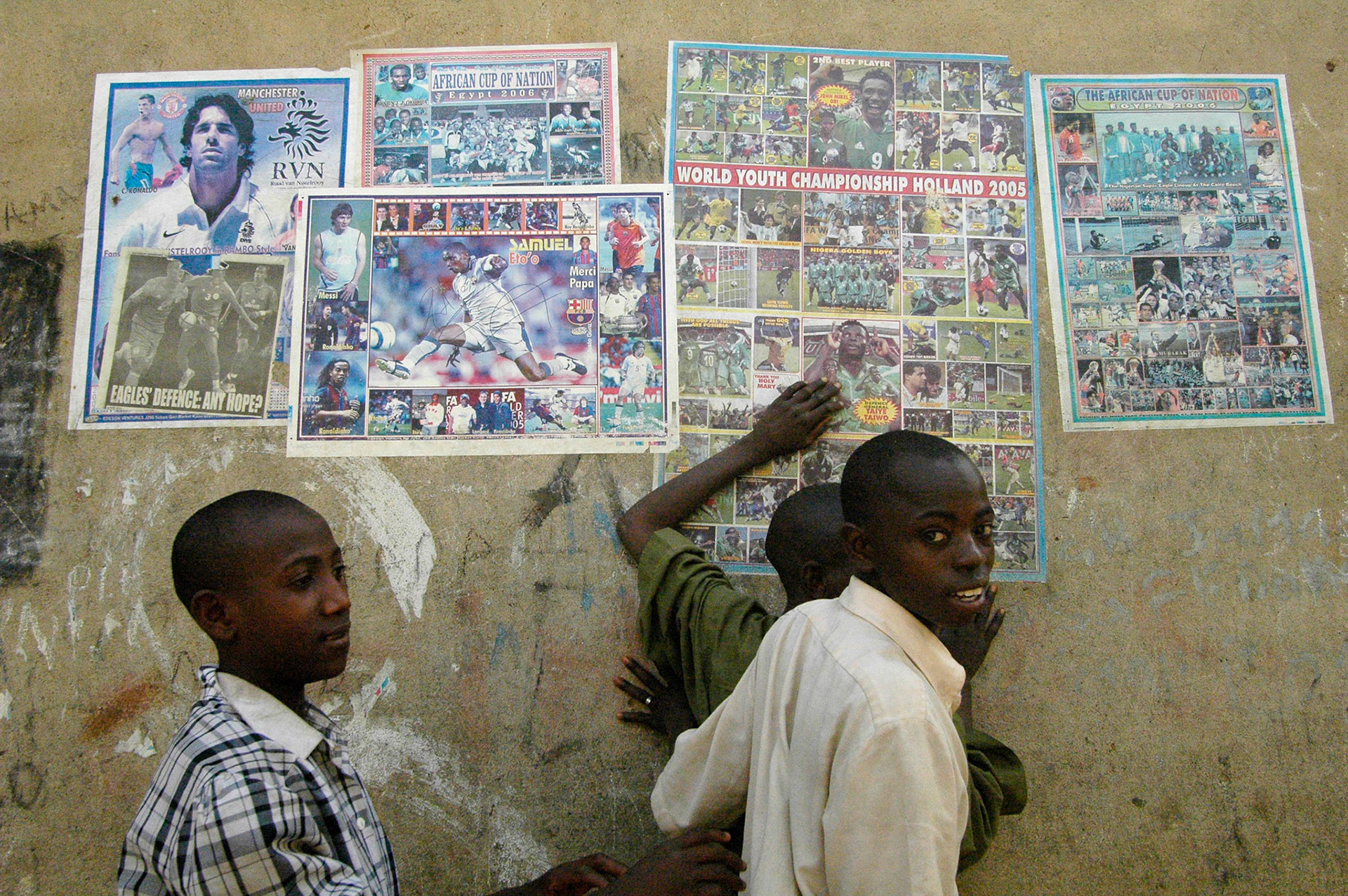 Voetbal posters, met Van Hooidonk, the African cup en wereld jeugd kampioenschap in Holland, in de straten van Kano (Nigeria) 13 april 2006