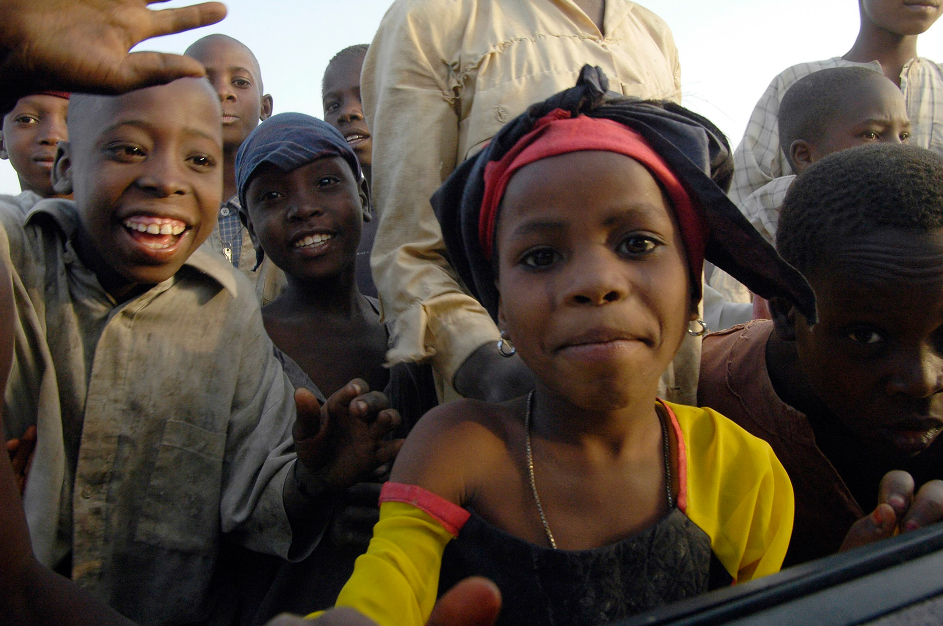 Nieuwsgierige kinderen aan de auto wuiven ons uit. Zaria (Nigeria) 11 april 2006