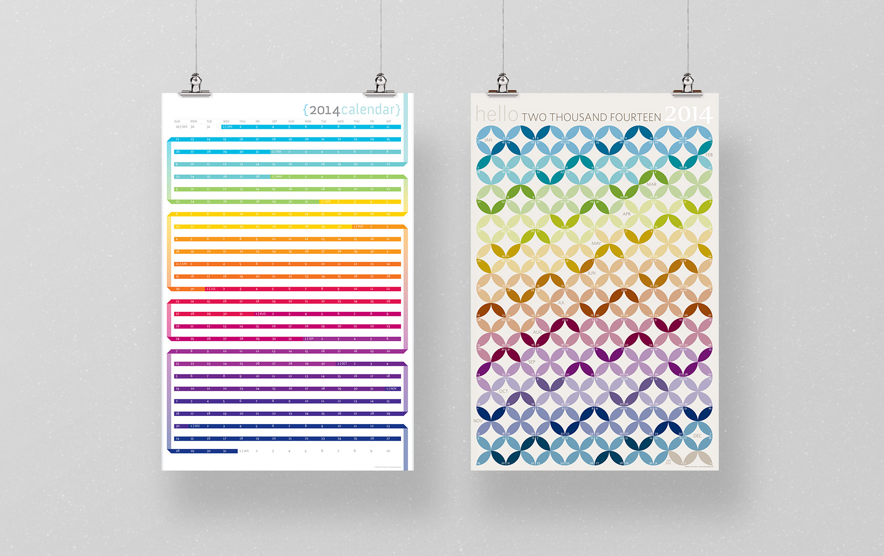 Two poster sized wall calendars with rainbow color themes.
