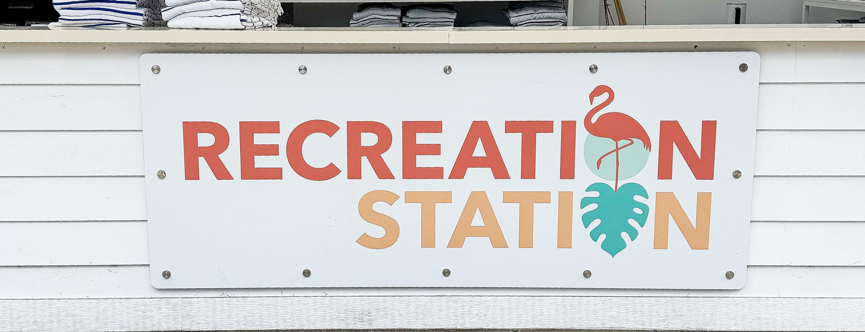Large sign on the front of a wood panel that says Recreation Station.