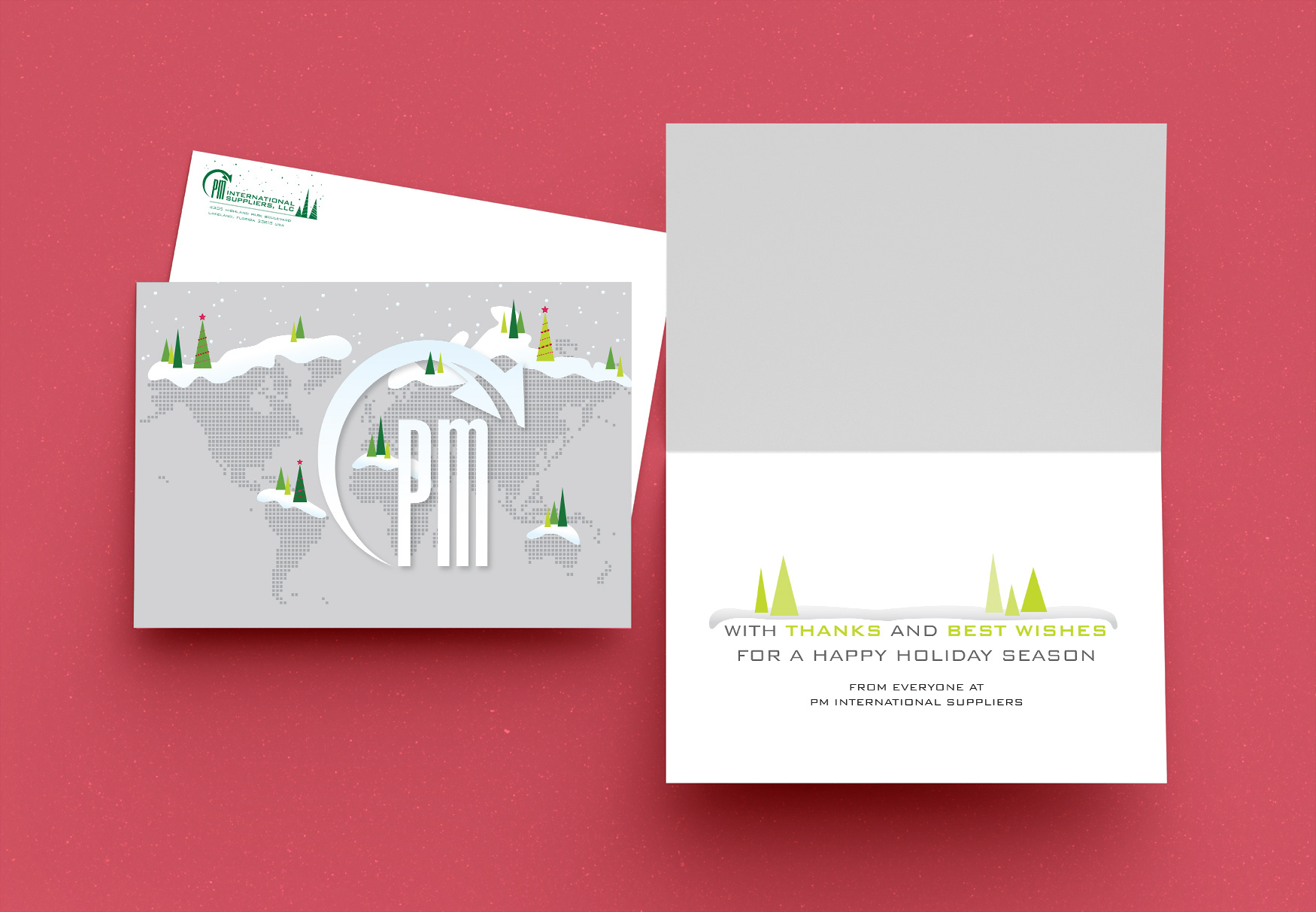 PM International Suppliers holiday card and envelope with a map of the globe in dots decorated with snow and trees.