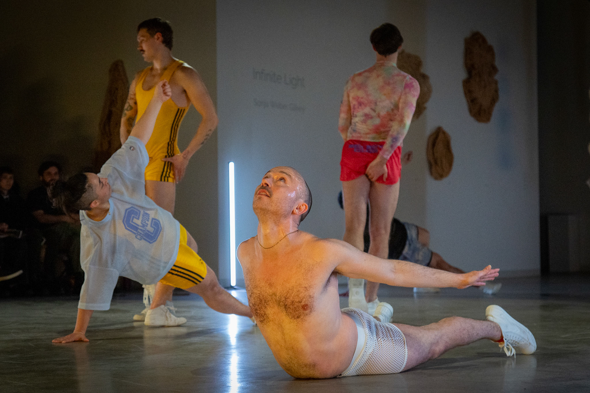 On April 11, 2025, at Cove Street Arts in Portland, Maine, “Bunk Beds” unfolded as an intimate, physical meditation on queer longing, devotion, and choreographic legacy. Directed by Tristan Koepke and created in collaboration with James Barrett, Emilia Bruno, Marc Macaranas, Daniel Miramontes, Benny Olk, and Curtis Thomas, the performance drew on the lives and love of Merce Cunningham and John Cage, Instagram thirst traps, and the radical possibilities of relationship anarchy.With live music composed and performed by Ethan Philbrick, lighting and production design by Audrey Kastner, and dramaturgy by Rebecca Steinberg, the piece layered movement, sound, and image into a performance that felt both deeply personal and expansively collective.