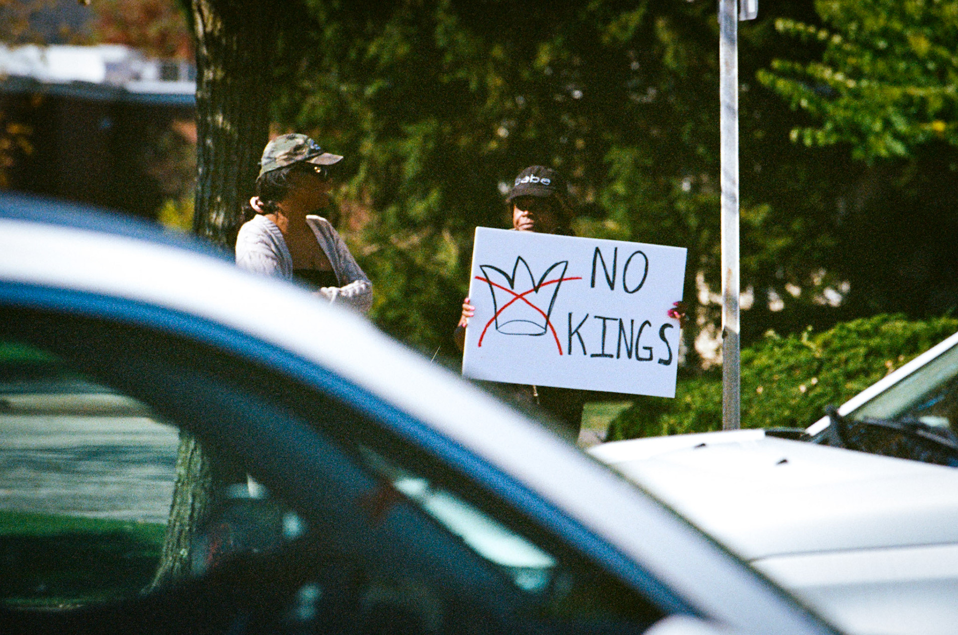 Protesters line SOM Center Road in Solon, OH on October ## 2025 to demonstrate against the Trump presidency and newly implemented policies on immigration.