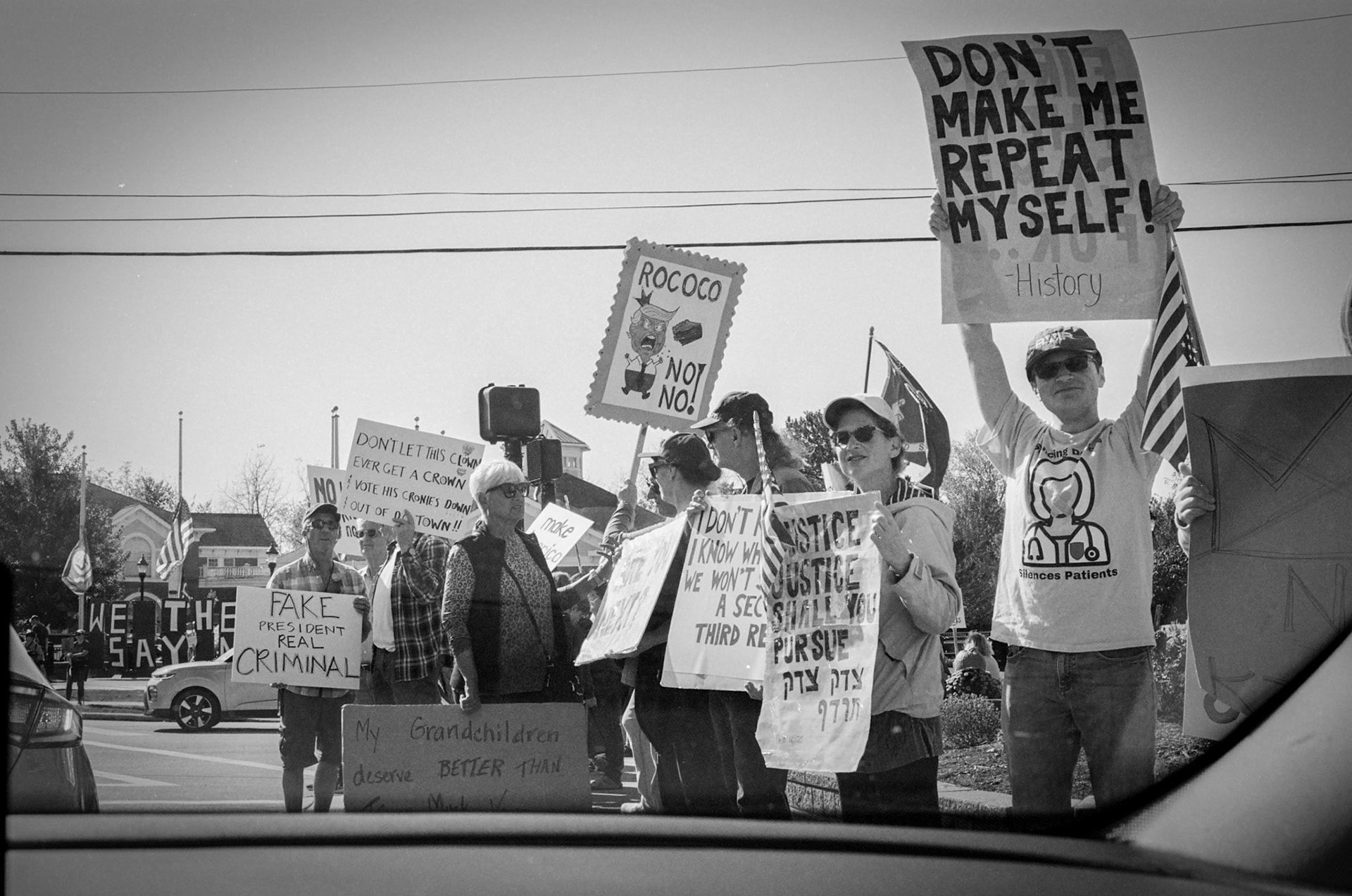 Protesters line SOM Center Road in Solon, OH on October ## 2025 to demonstrate against the Trump presidency and newly implemented policies on immigration.