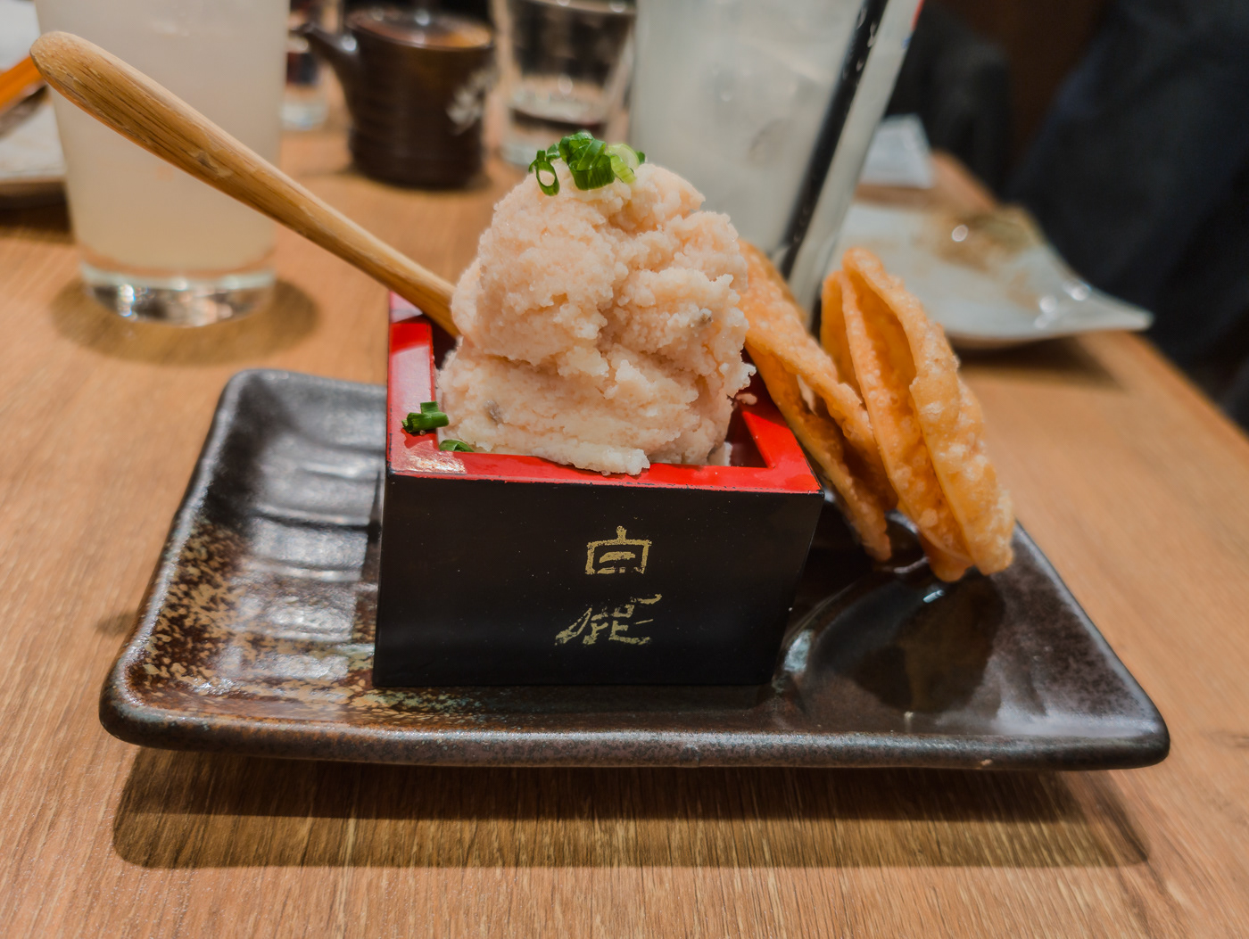 Fish roe spread on fried gyoza wrapper crackers