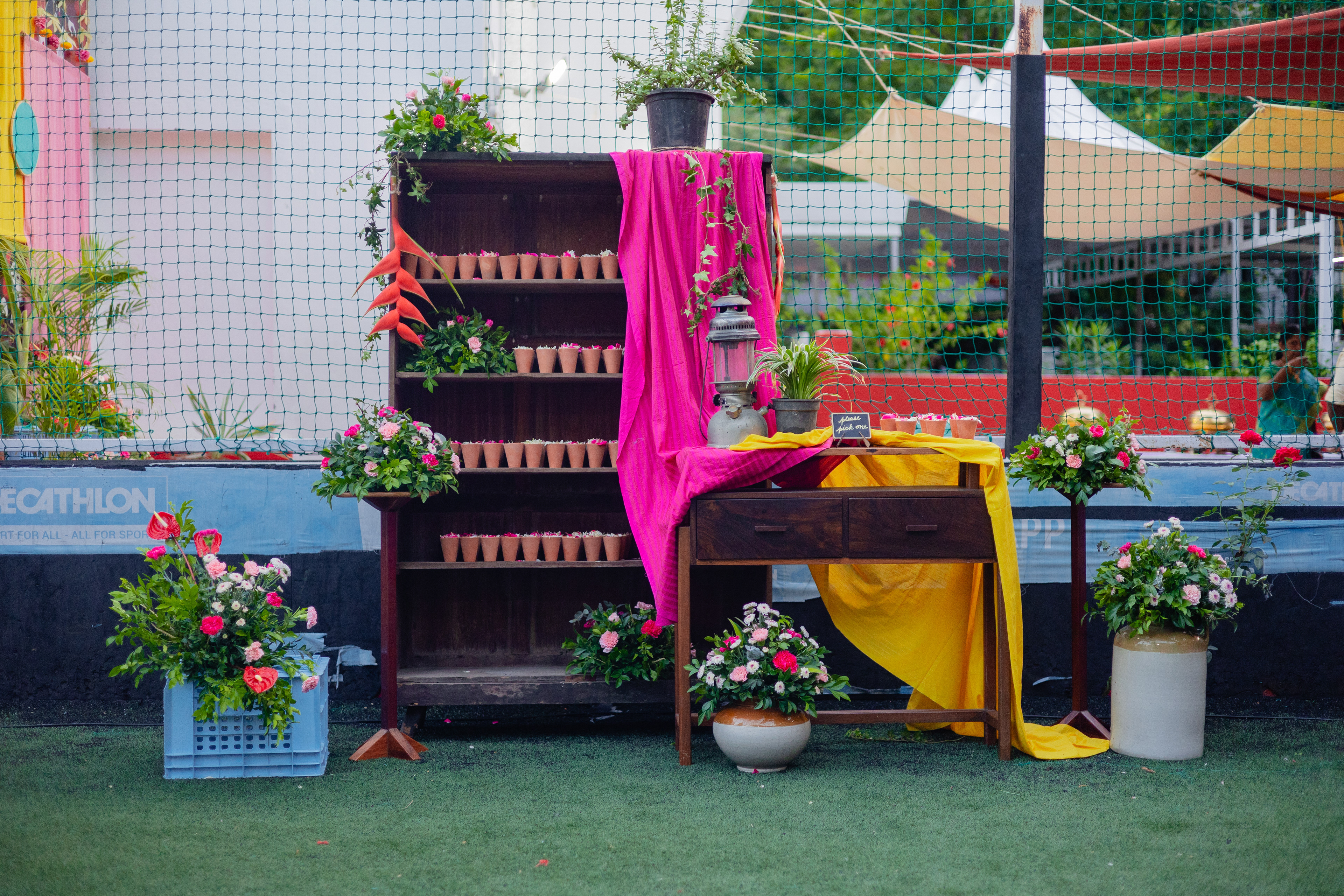 Ubiquitous 'thakkali pettis' were painted a bright blue and used as a base for quirky floral arragnements.