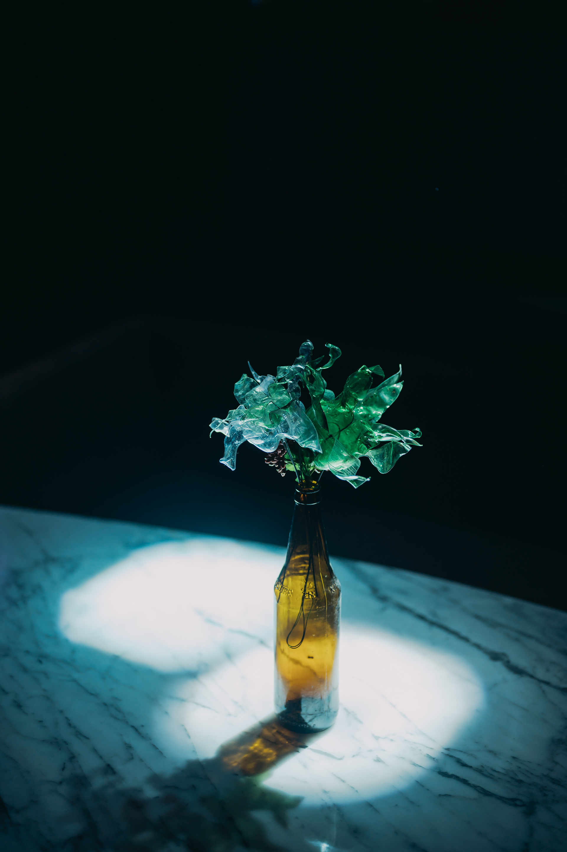 Old discarded plastic bottles were hand cut and shaped into flowers, that were used as table toppers.