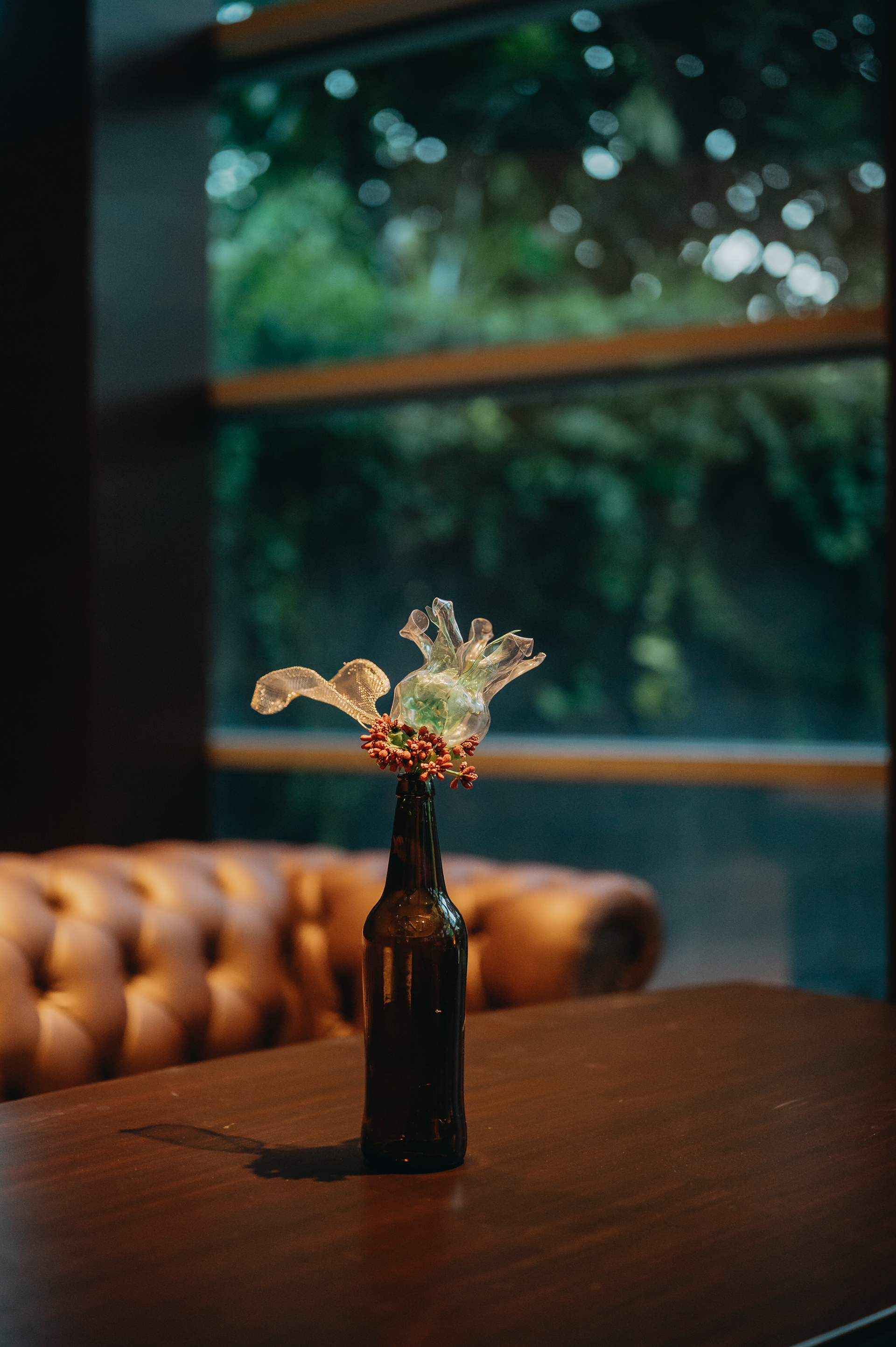 Old discarded plastic bottles were hand cut and shaped into flowers, that were used as table toppers.