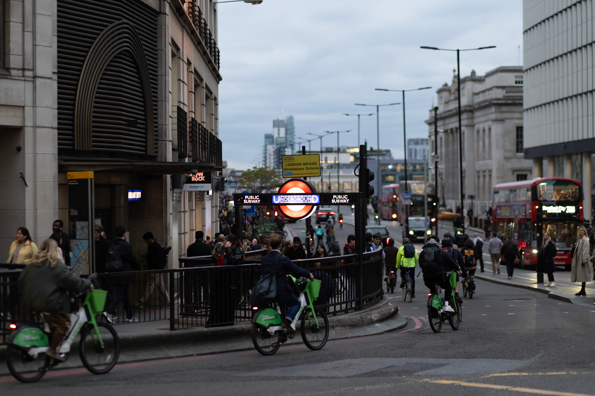 Cycling towards London Bridge with Monument station sign in view