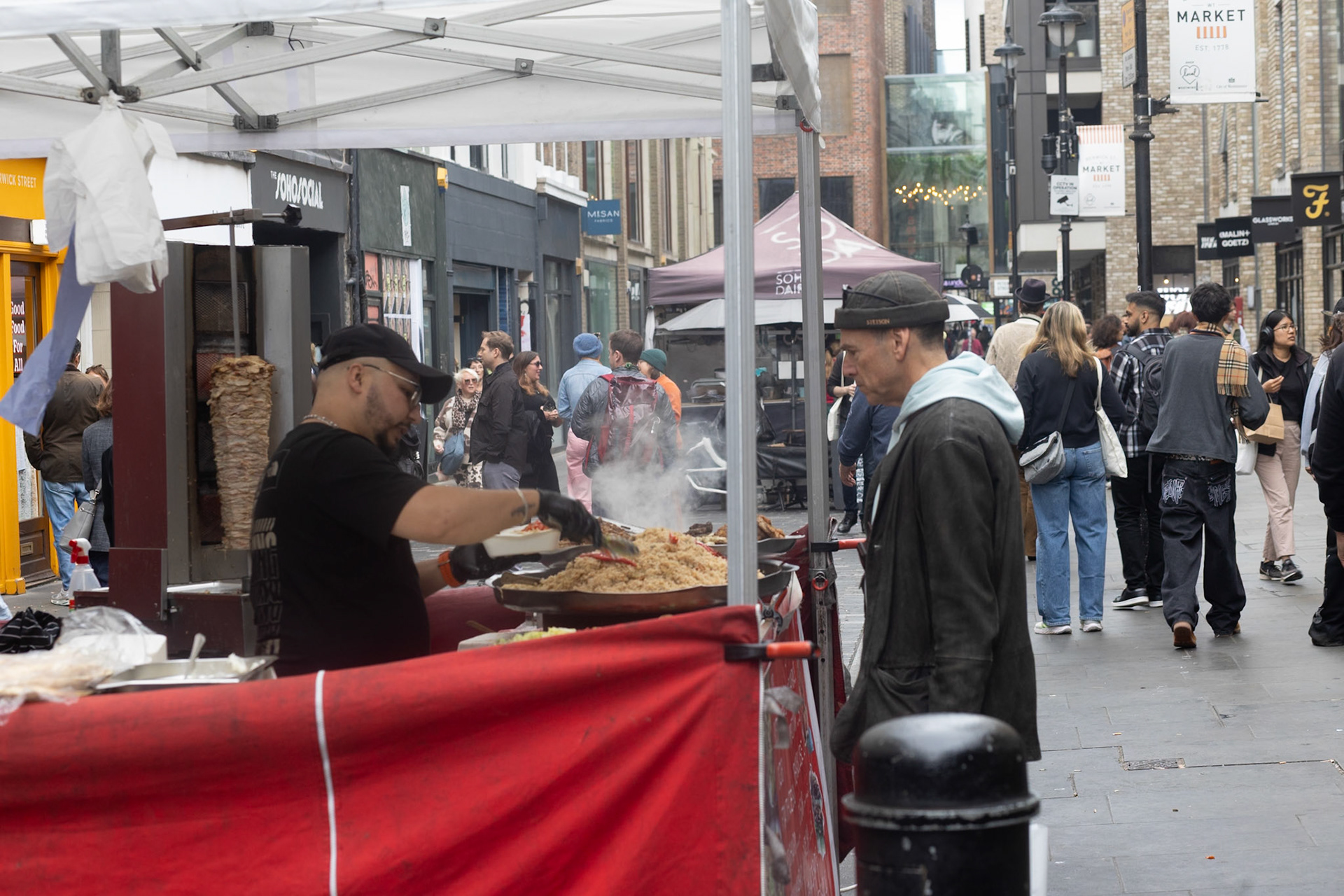 Buying food at Berwick Street market