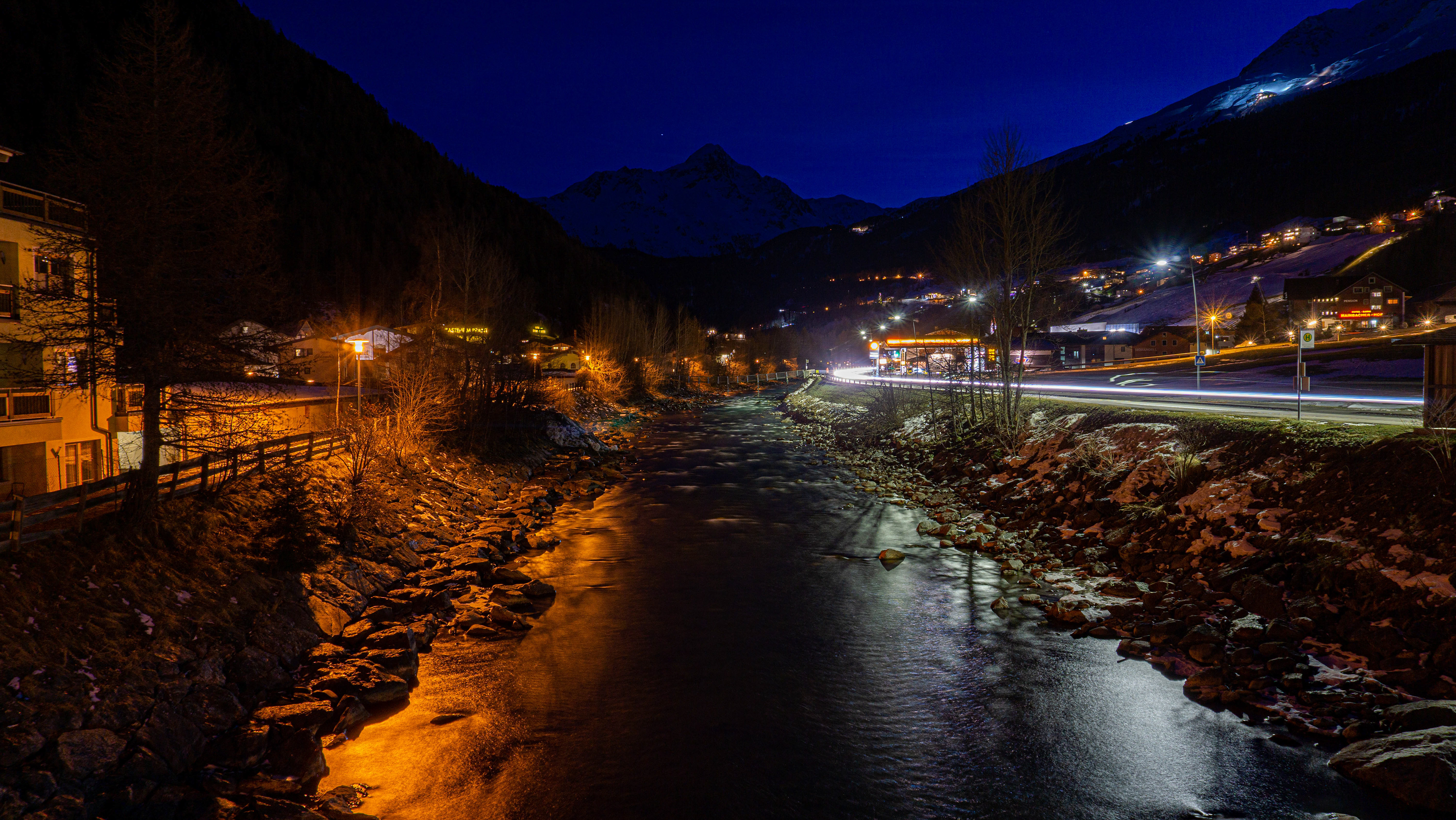 Photo of a lake running through a town at night