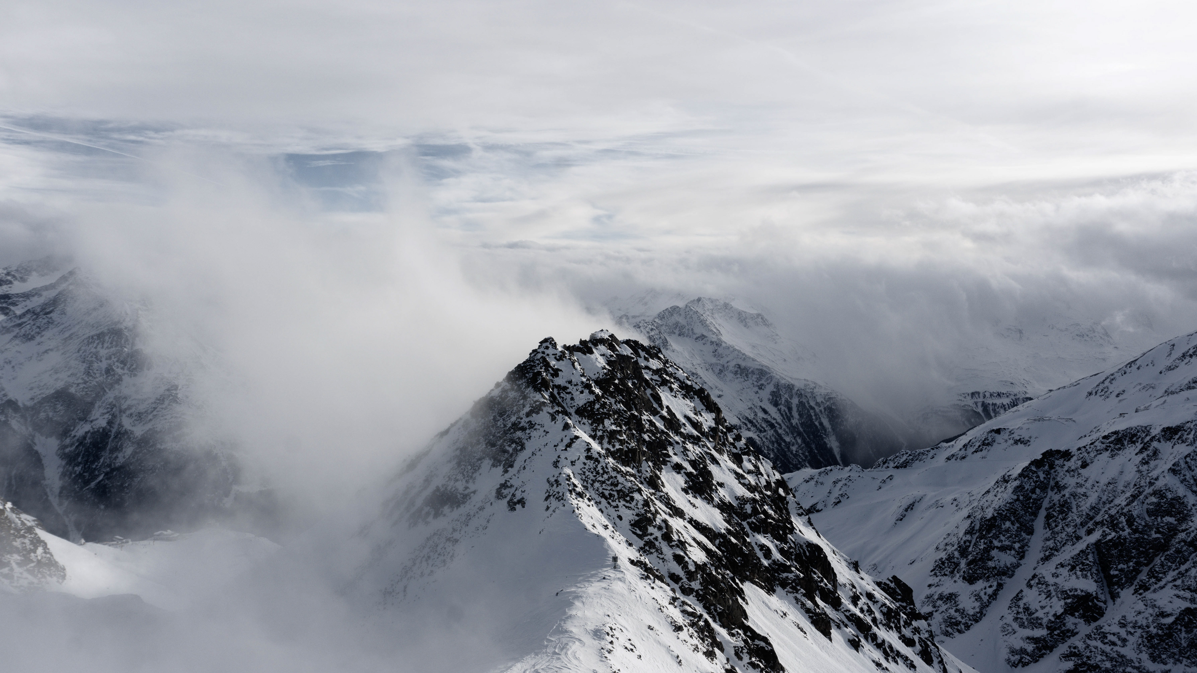 white mountain peak in the clouds