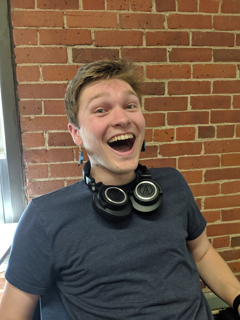 Coworker Stephen wearing his custom Draft Resin earrings
