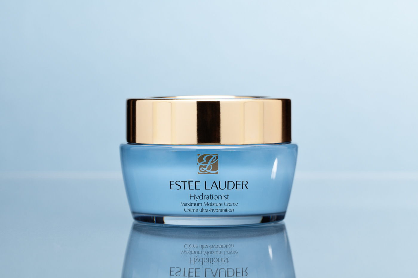Cosmetics creme pot Estee Lauder on blue background
