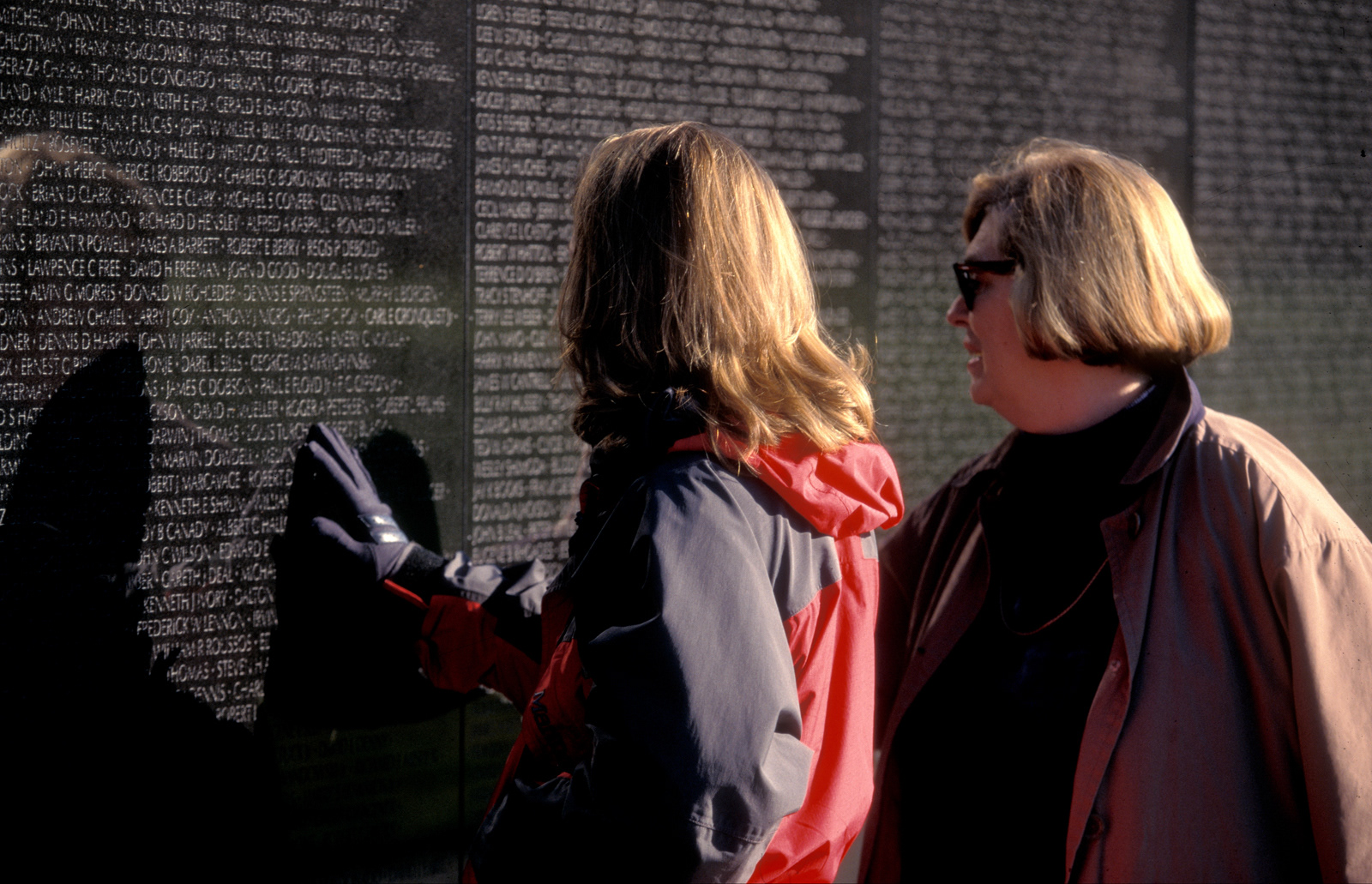 Mother and daughter at the Vietnam War Memorial, Washington DC, USA