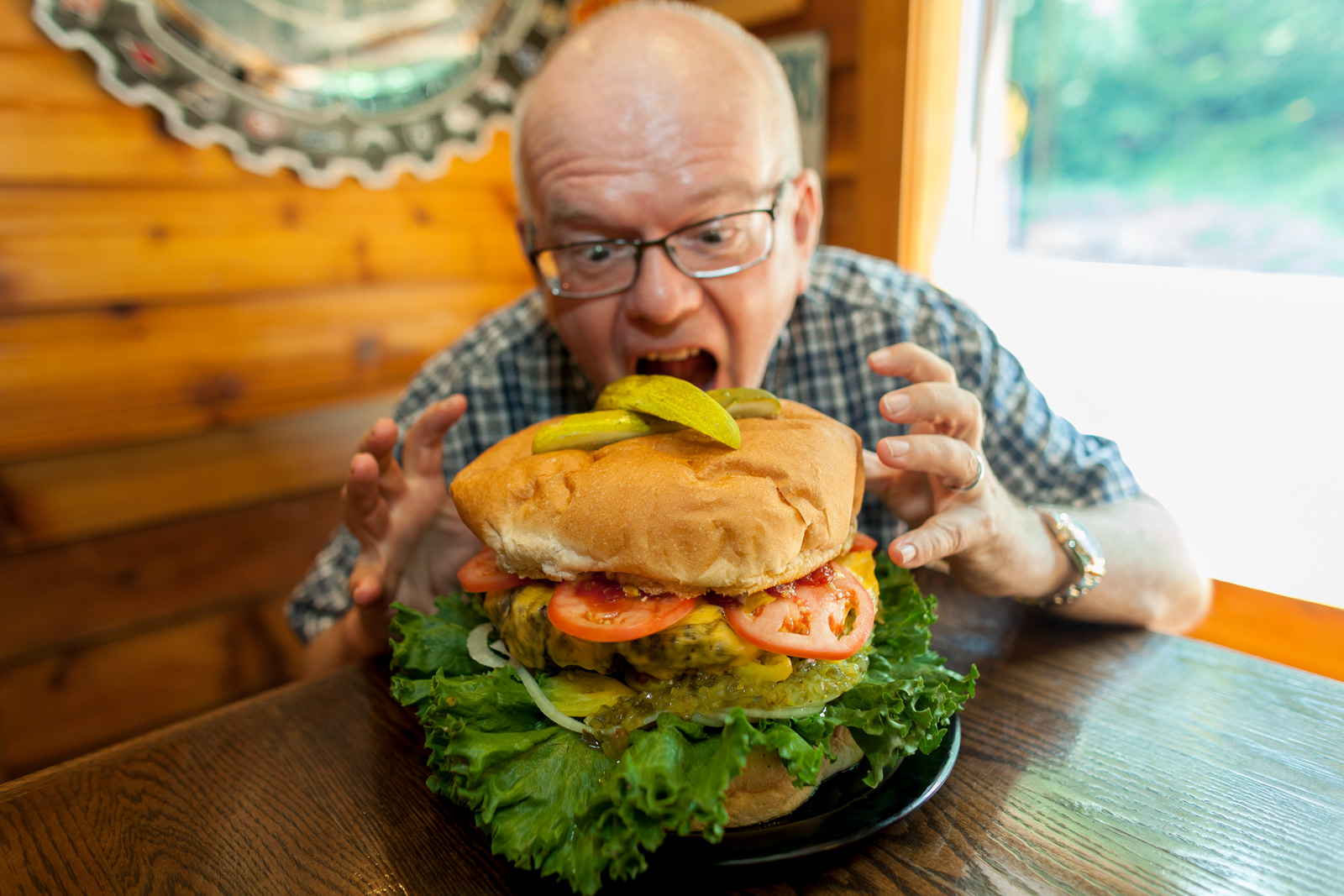 Man eating a giant hamburger, Pennsylvania, USA