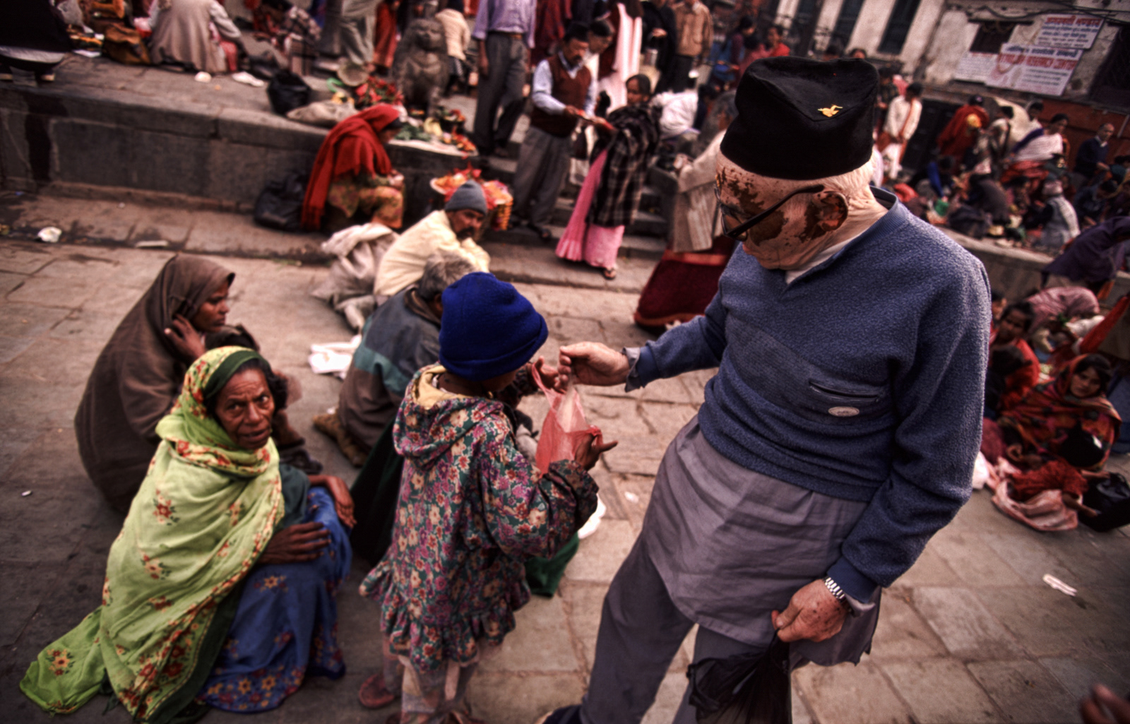 Giving away food, Durbar Square, Bhaktapur, Nepal