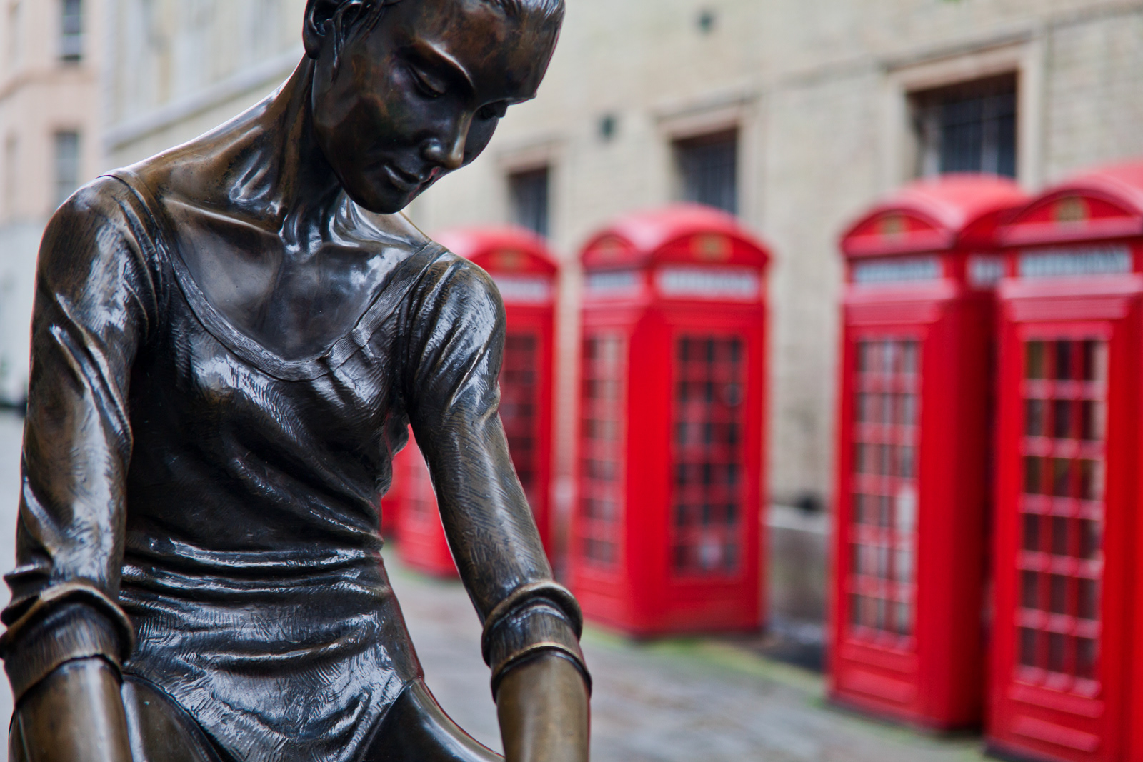 Dancer and phone boxes, Covent Garden, London, UK