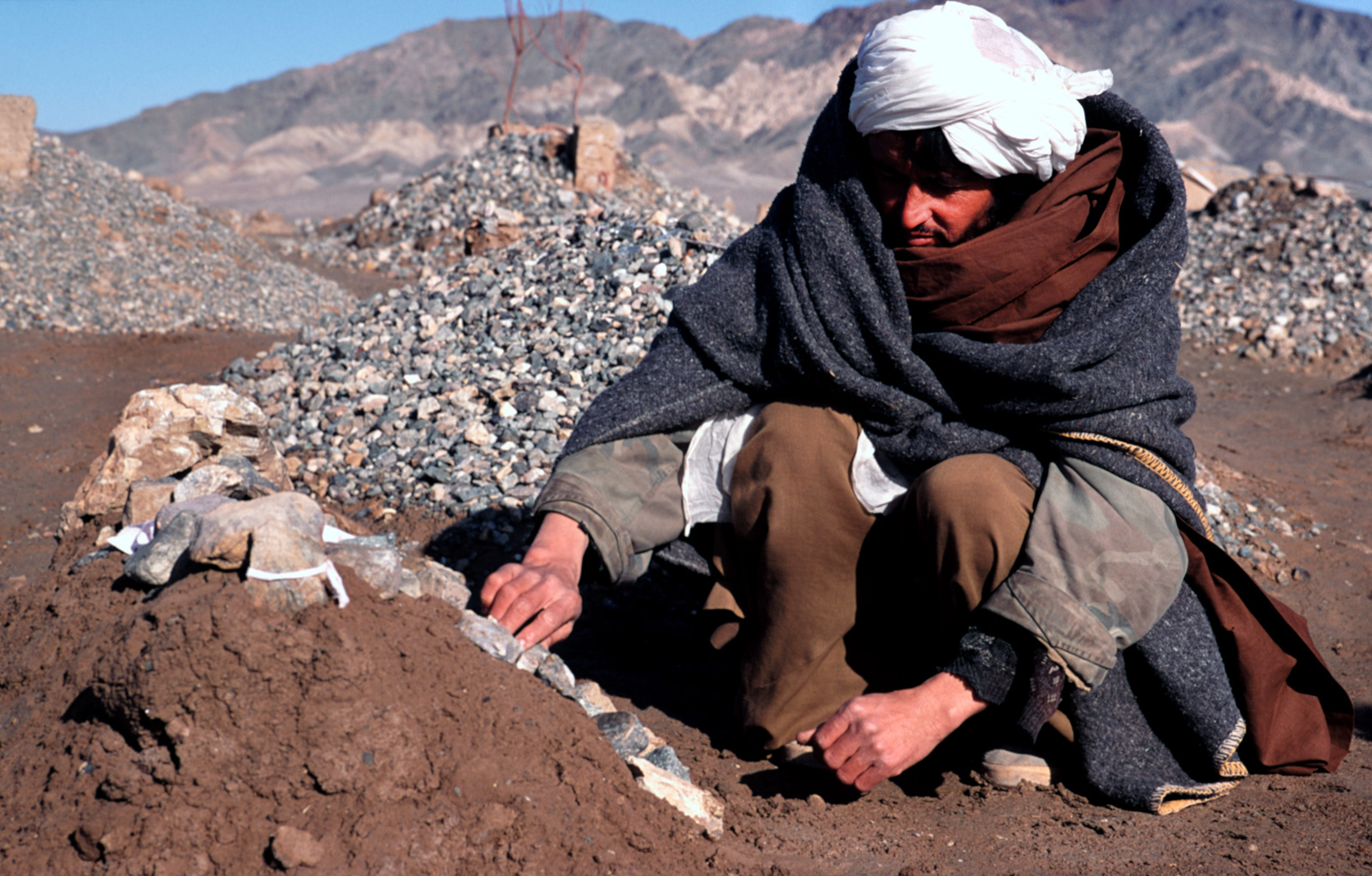 Man burying daughter, Maslak Refugee Camp, Herat, Afghansitan