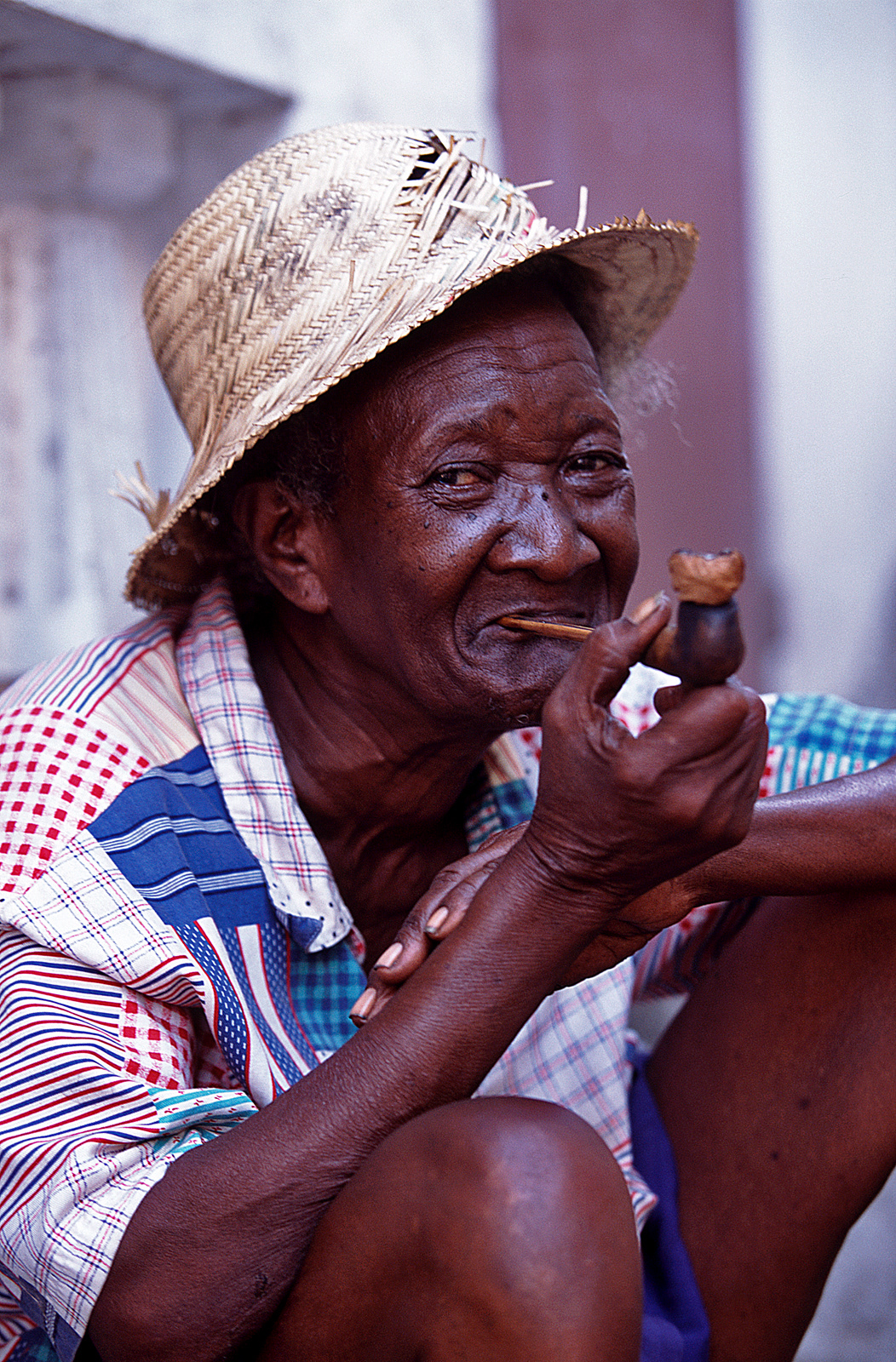 Lady smoking corn cob pipe, Port-au-Prince, Haiti