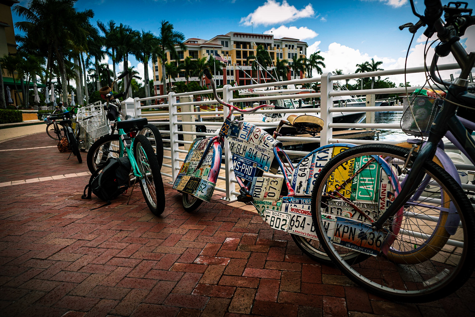 Bicycles leaning up against a railing in a marina in Riverwalk Florida, while on a pub crawl.