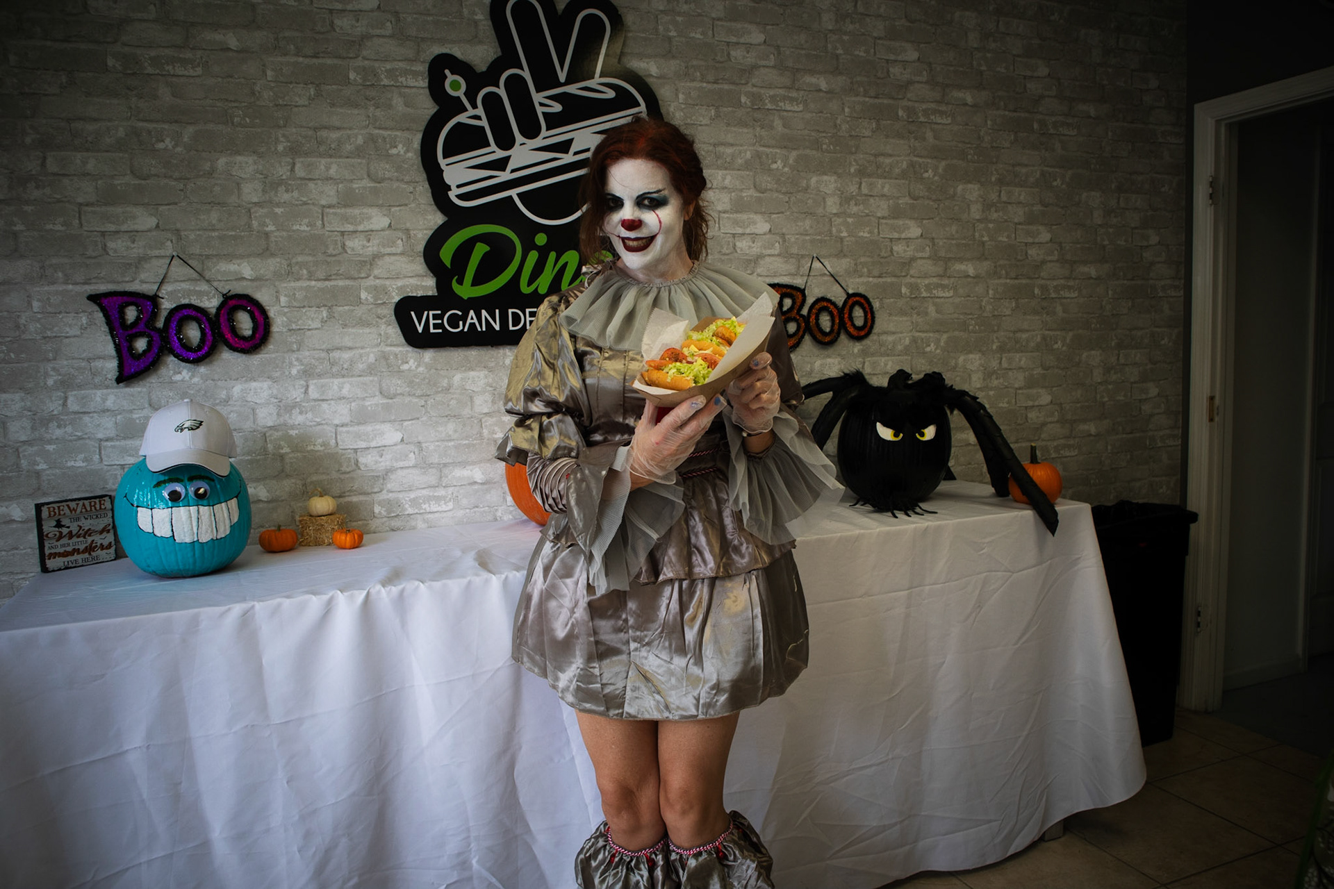 Dina dressed up as pennywise showing off an Italinan stallion hoagie.