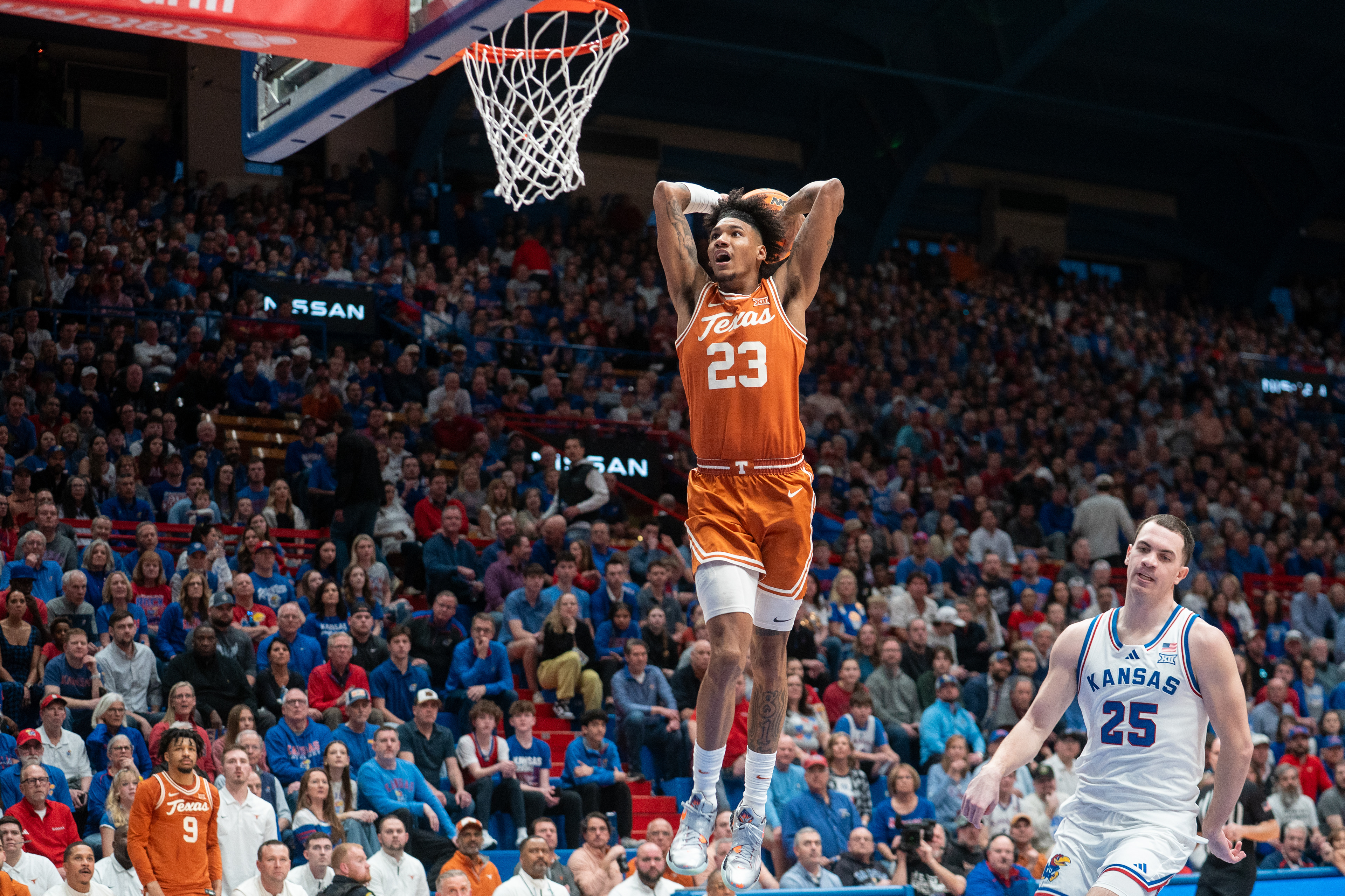 Texas forward Dillon Mitchell (23) goes up to dunk in the first half of a college basketball game against the Kansas Jayhawks at Allen Fieldhouse in Lawrence, KS., Saturday, Feb. 24, 2024.
