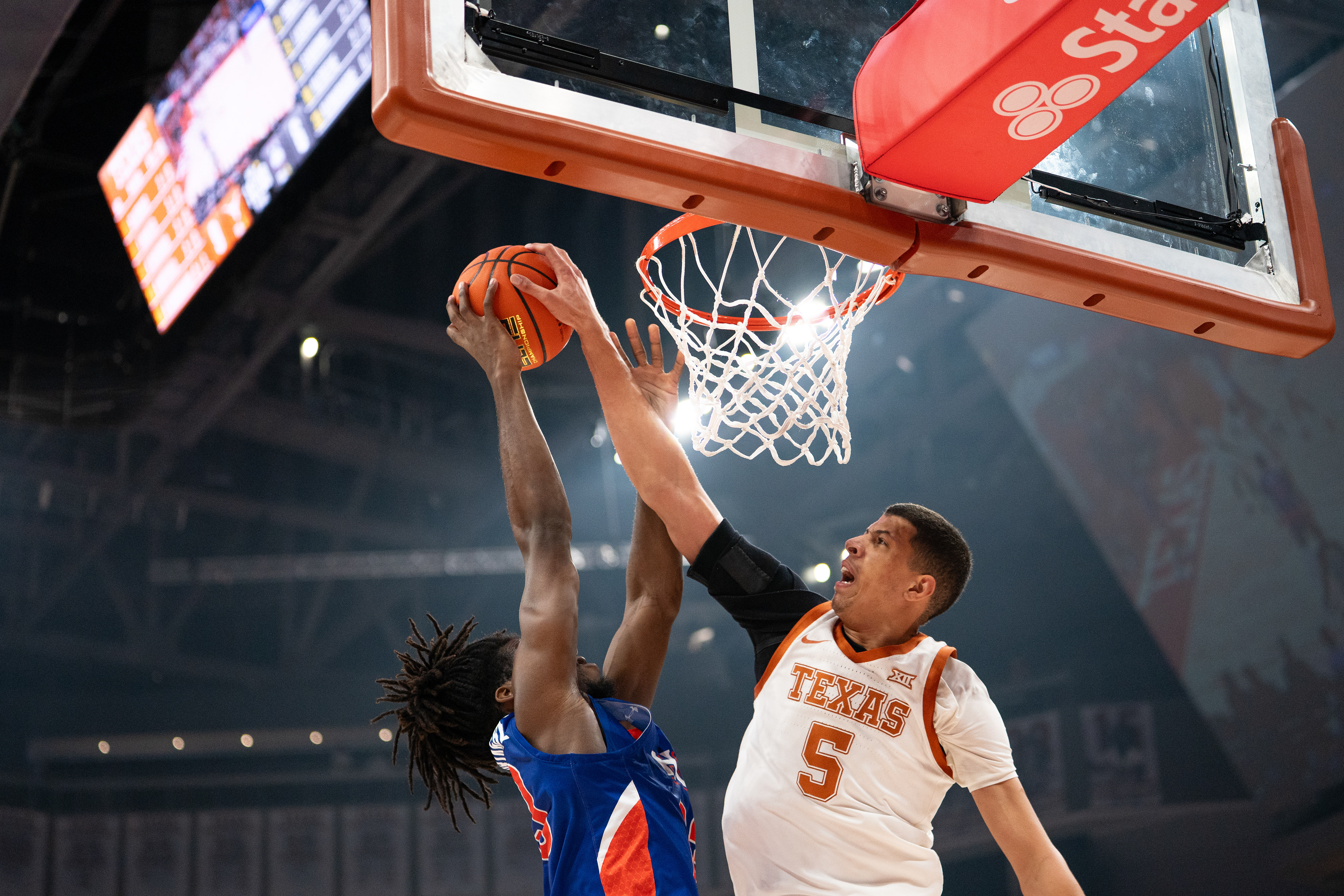 Texas center Kadin Shedrick (5) makes block against a layup attempt from Houston Christian Michael Imariagbe (33) in the first half at Moody Center in Austin, TX., Saturday, Dec. 9, 2023.