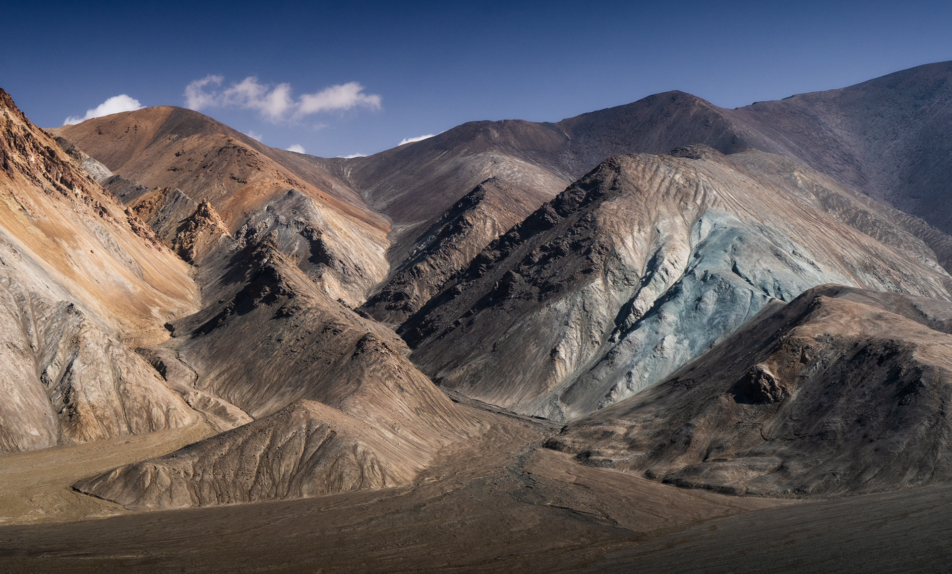 Dry, parched mountains of different colours in Tajikistan